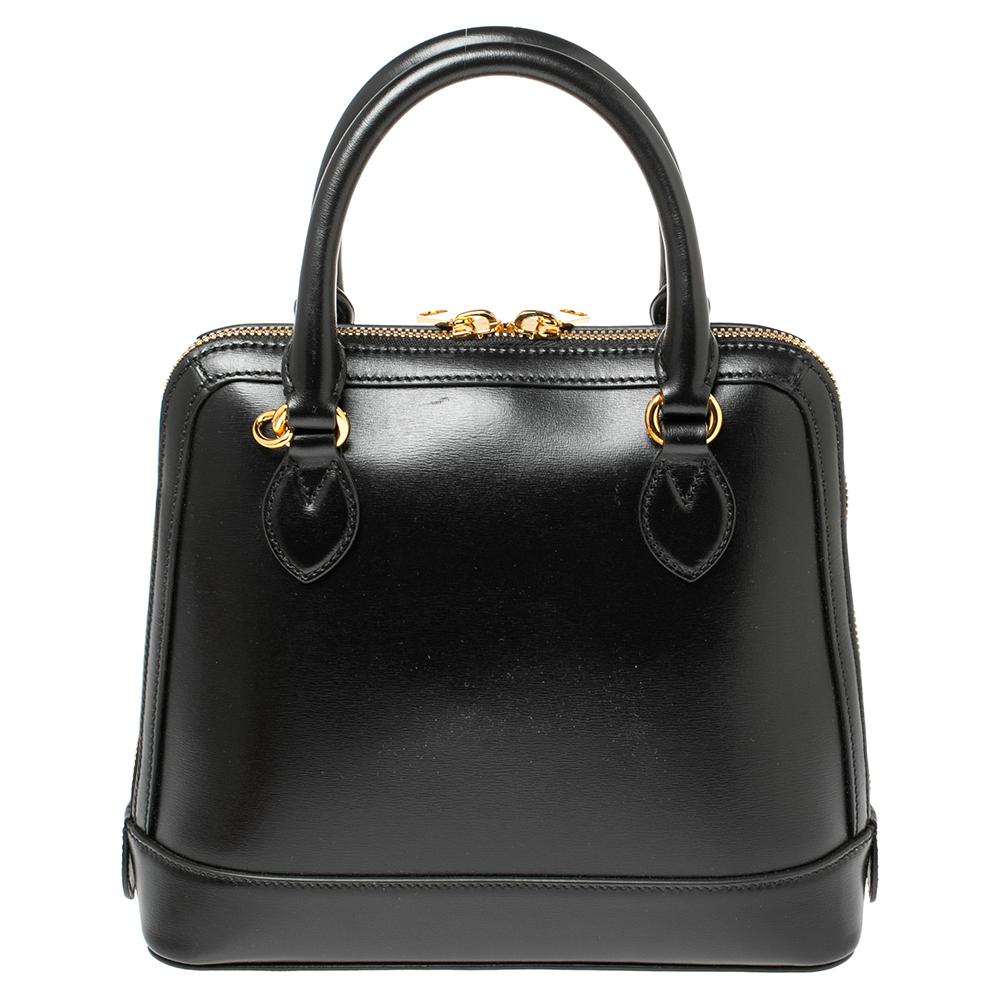 This stunning piece manifests Gucci's take on a classic satchel. It features the distinctive Horsebit accent on the front. Its black-hued leather exterior is framed beautifully with a top handles. A roomy interior is convenient to stow away your