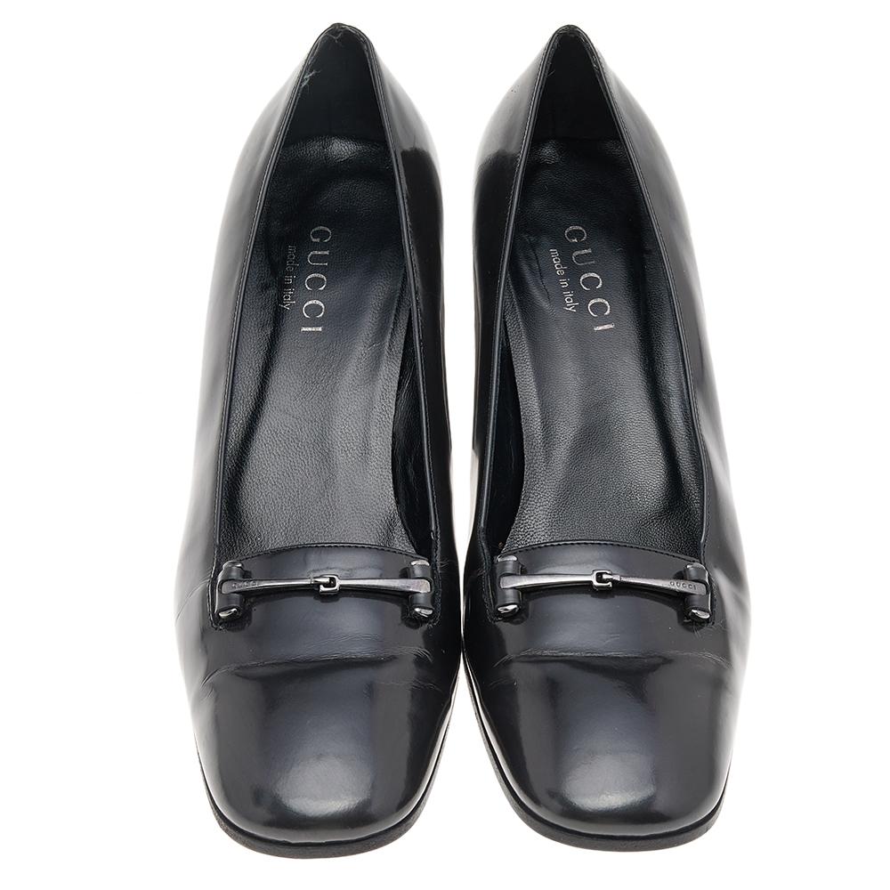 Gucci's expertise in crafting high-quality leather goods is evident through the creation of these pumps. They are designed using black leather with a Hosebit motif highlighting the upper. They feature square toes, a slip-on style, and block heels.