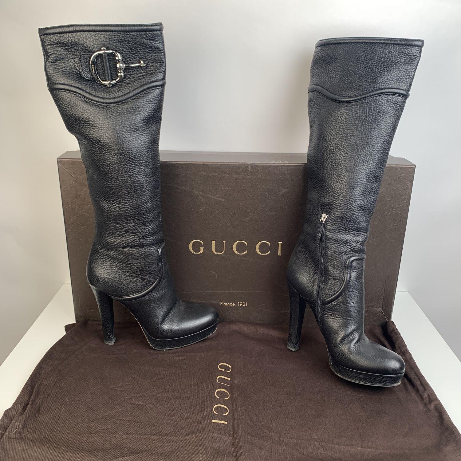 Gucci knee high boots in black leather. Gold metal horsebit on the upper part. Side zip closure. Platform: 1 inches - 2,6 cm. Heels: 5 inches - 12,7 cm. Shaft height: 15.25 inches - 38.7 cm. Almond toes. Size: 40 (The size shown for this item is the