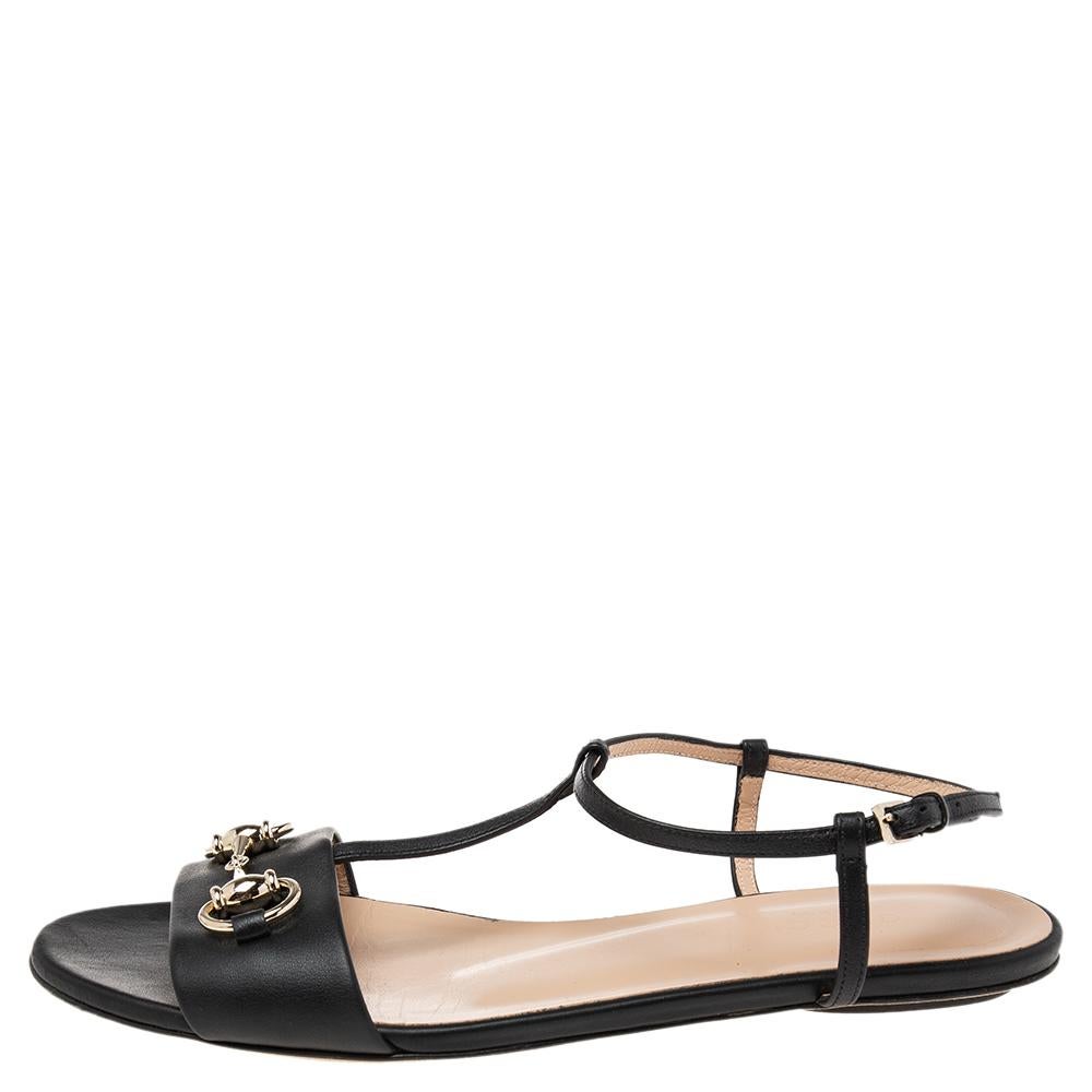 Designed to keep your steps light and stylish, these Gucci flats are made using leather. They feature open toes, Horsebit accents on the uppers, and buckle closure around the ankles. The black flats will be a great option on any day.

Includes: