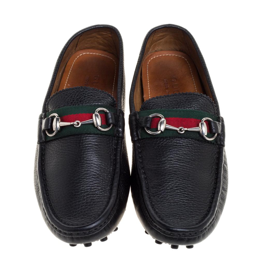 Crafted from leather, this pair of black Driver loafers by Gucci is a blend of luxury and comfort. They feature the signature Web trim and Horsebit motif on the uppers, leather-lined insoles, and rubber pebbling on the outsoles. The loafers are