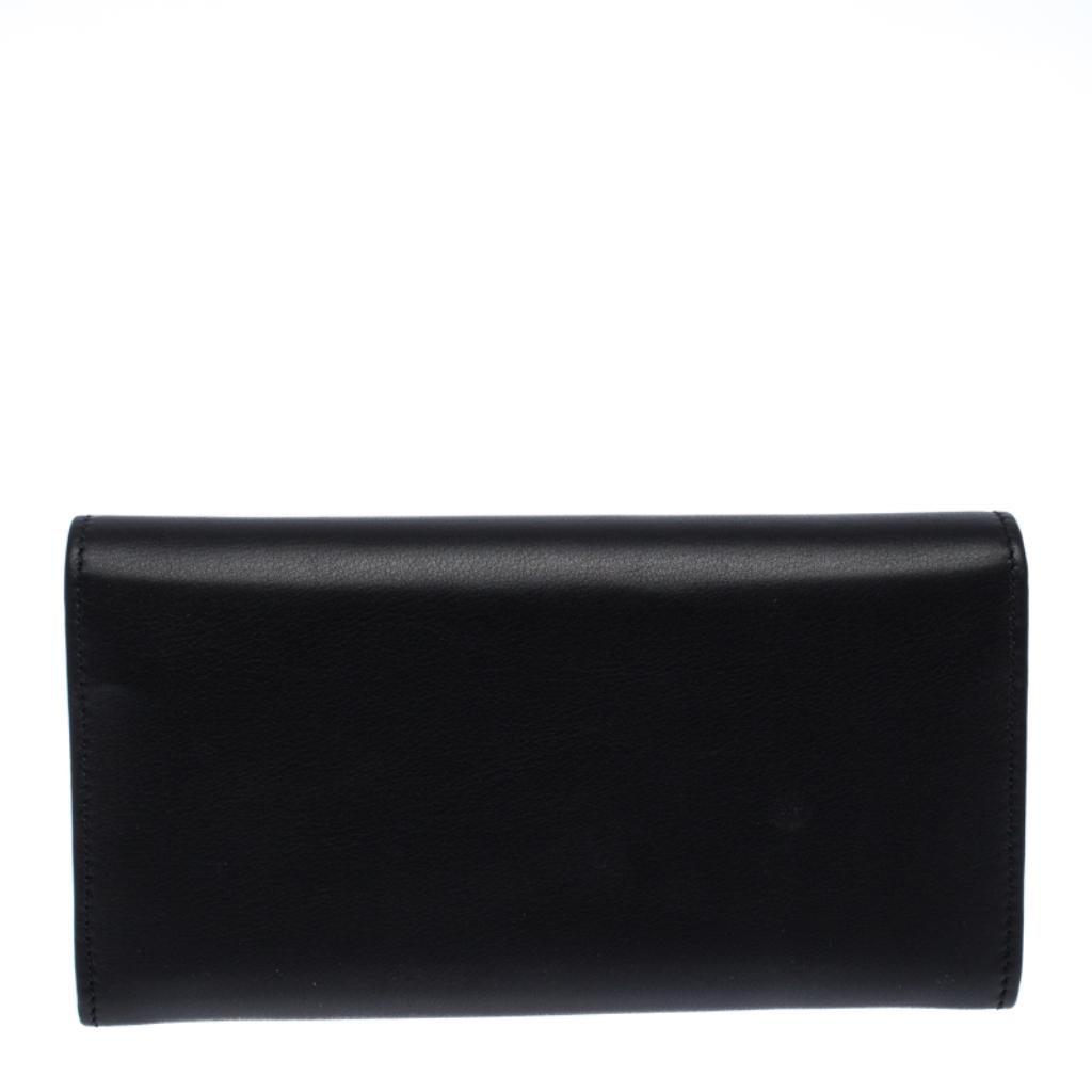 Crafted from leather, this gorgeous continental wallet from Gucci carries a timeless black exterior. The slender flap is accented with the signature interlocking GG motif embellished with crystals and opens to an interior equipped with multiple