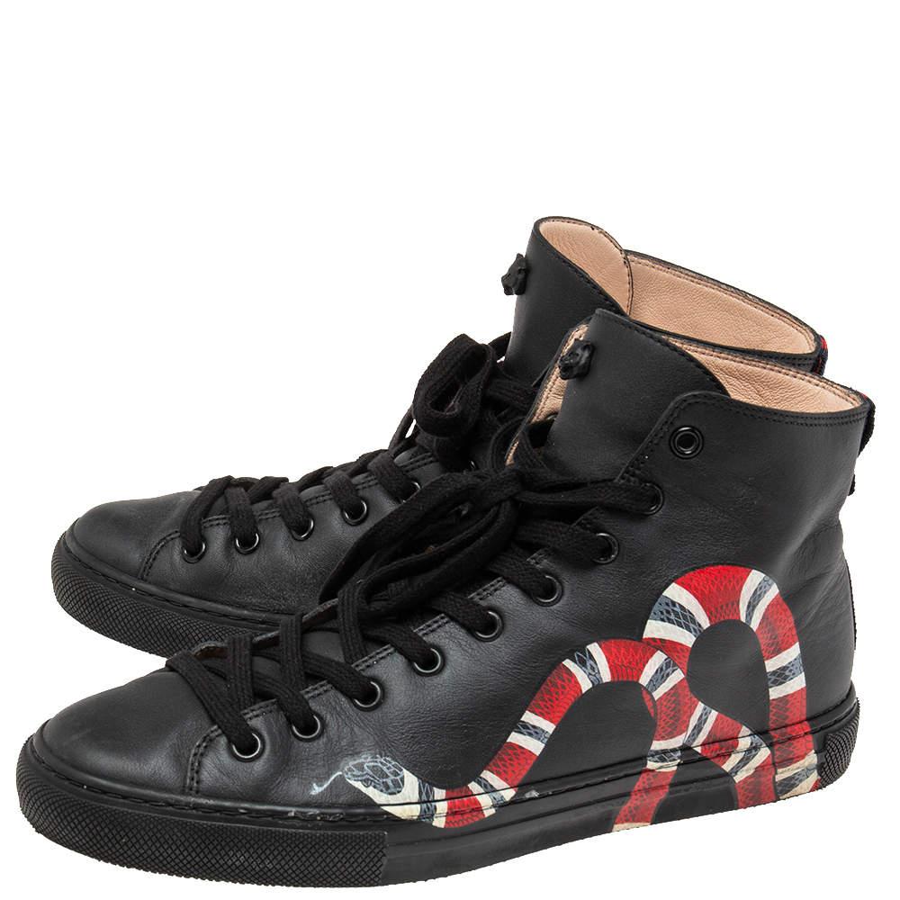The house of Gucci's attraction for wildlife is evident from its menagerie of animal motifs seen across its collections. An eye-catching kingsnake motif is featured on the side panels of these high-top sneakers. They are crafted in black leather,