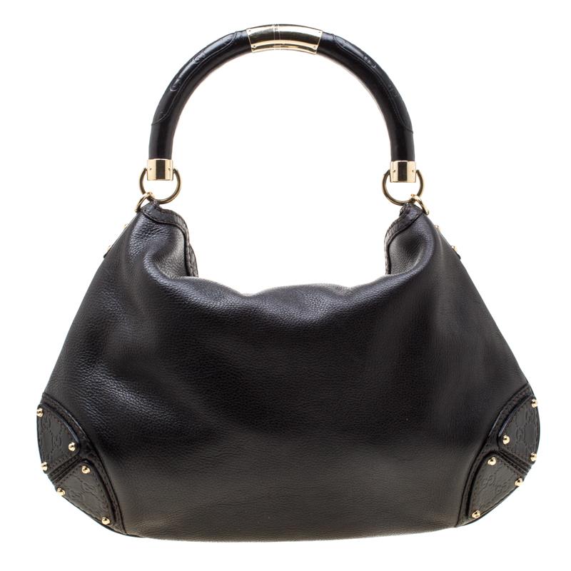 Crafted from leather, this Gucci number has a top with two bamboo-detailed tassels and a spacious canvas interior. It also features a sturdy top handle, armoured corners, and gold-tone hardware. Flaunt this beauty wherever you go and you'll surely