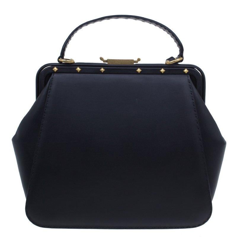 This Lady Stirrup bag from the house of Gucci is a limited edition bag from FW's collection. Crafted from black leather, it features a structured design with antique gold-tone hardware, stud details and a front gusset pocket. The bag comes with a