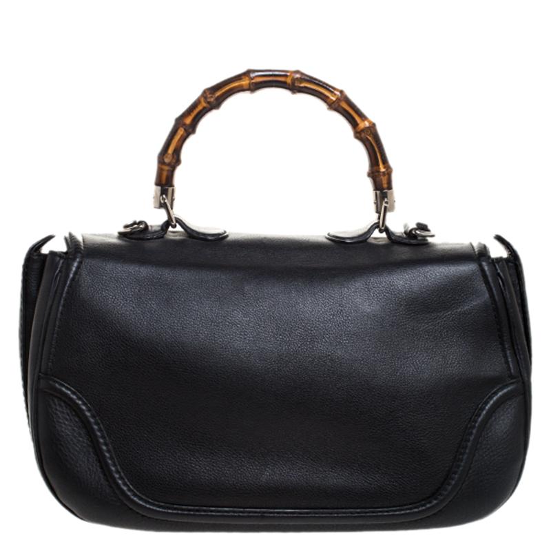 Add a touch of artistic blend to your outfit with this Gucci bag. Crafted with Gucci’s classic bamboo detailing, this black bag is a timeless piece. It features a leather exterior with a bamboo detailed handle, twist-lock closure and tassels on one