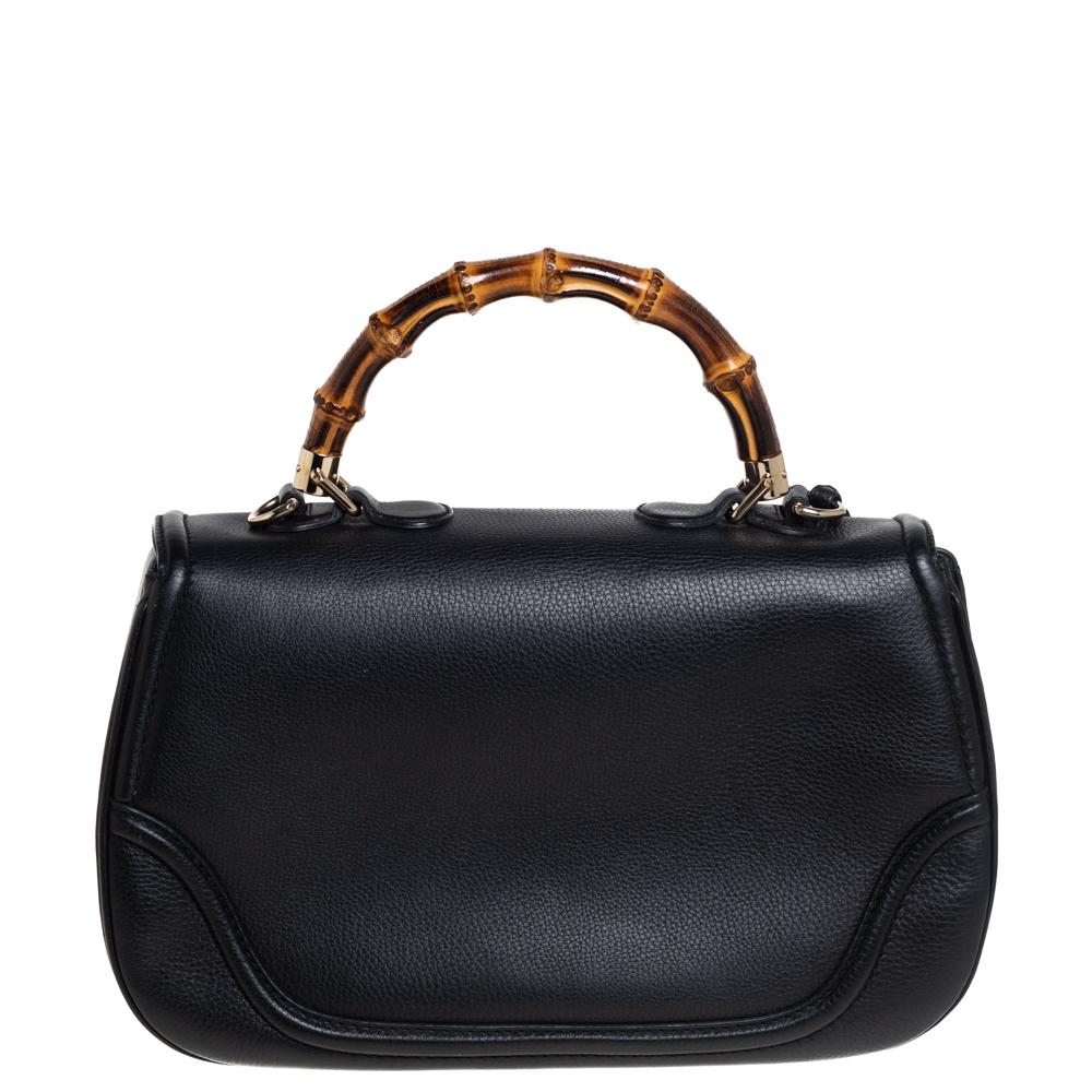 Bags from Gucci are on every woman's wishlist. So, own this gorgeous bag today and light up your closet! Crafted from leather, this fabulous black number has a front flap that is detailed with the signature bamboo motif as the turn-lock and opens to
