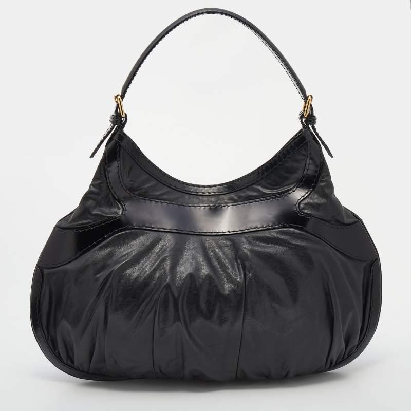 Hobos are fashionable and utilitarian as well. This one by Gucci is the perfect example. It comes in black leather with a single carry handle. Adding a shine to the bag comes the contrasting gold-tone details and the chunky bow-buckle on the