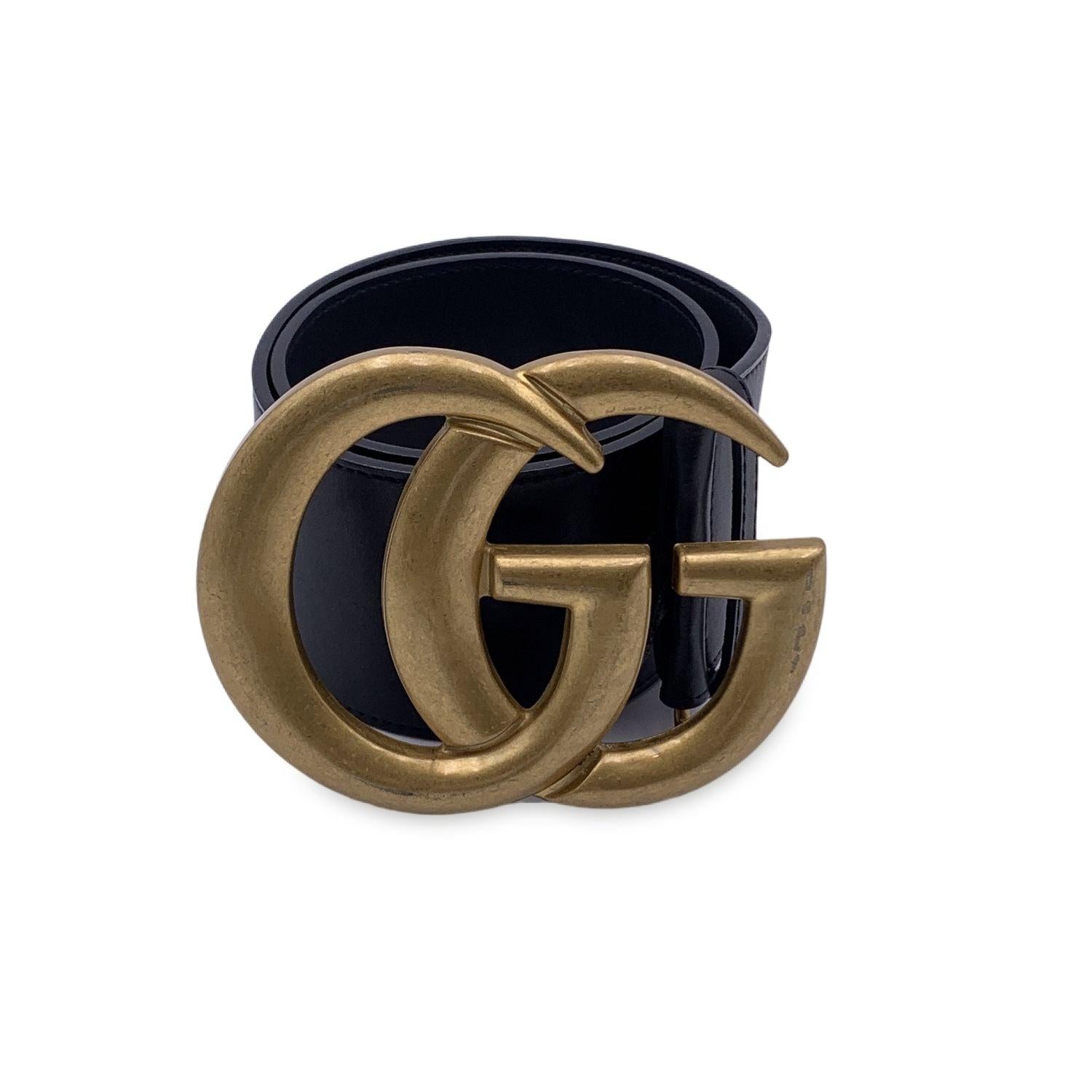 Gucci Marmont wide belt in black leather with GG logo pattern. Big gold metal GG buckle. Width: 2.6 inches - 6.7 cm. 'GUCCI - Made in Italy' engraved on the reverse of the belt, serial number engraved on the reverse of the belt. 5 holes adjustment.