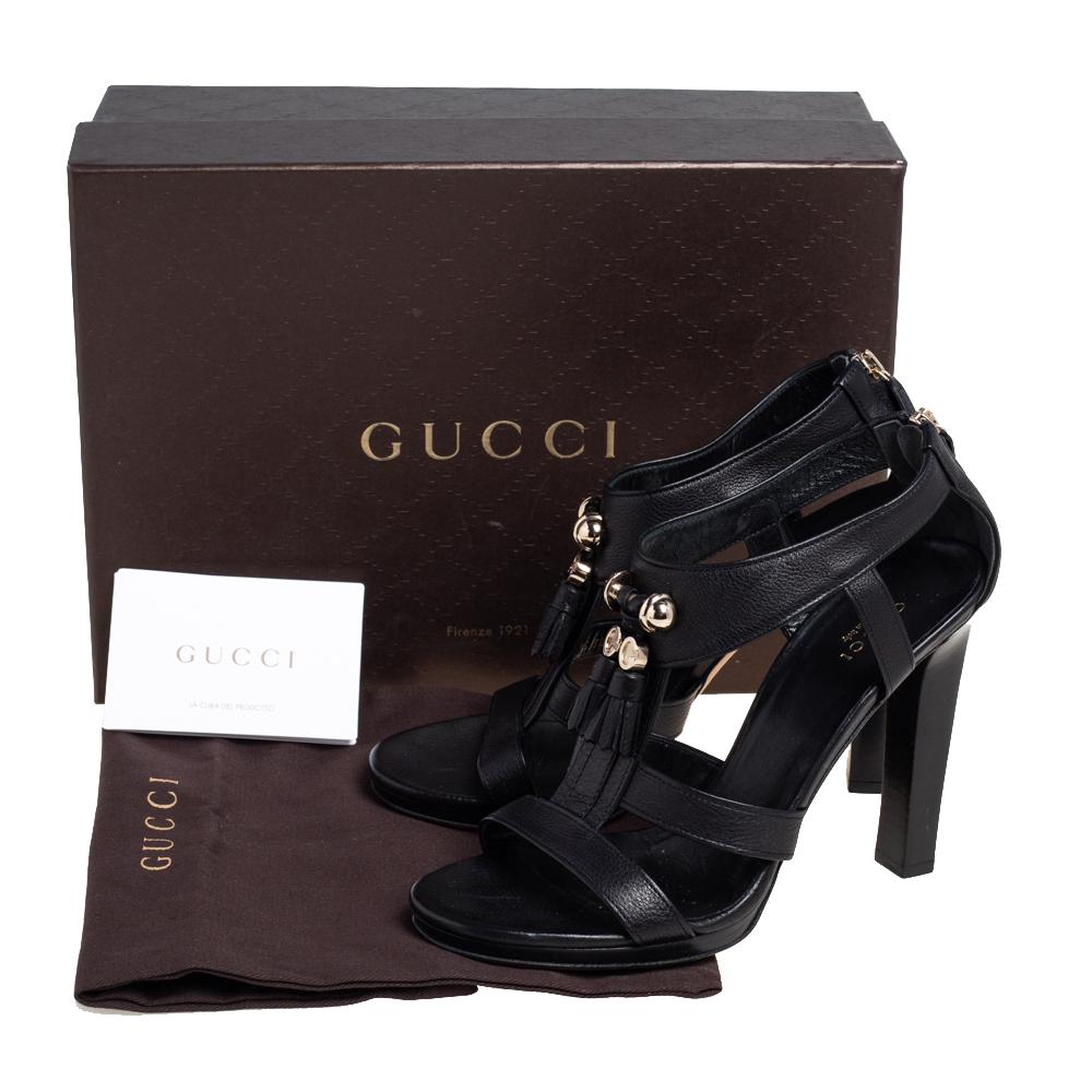 These ‘Marrakech’ sandals by Gucci bring a bohemian touch in a subtle way. They feature leather straps with tassels on the front, back zippers, and block heels supported by low platforms. The black sandals are well-made and easy to
