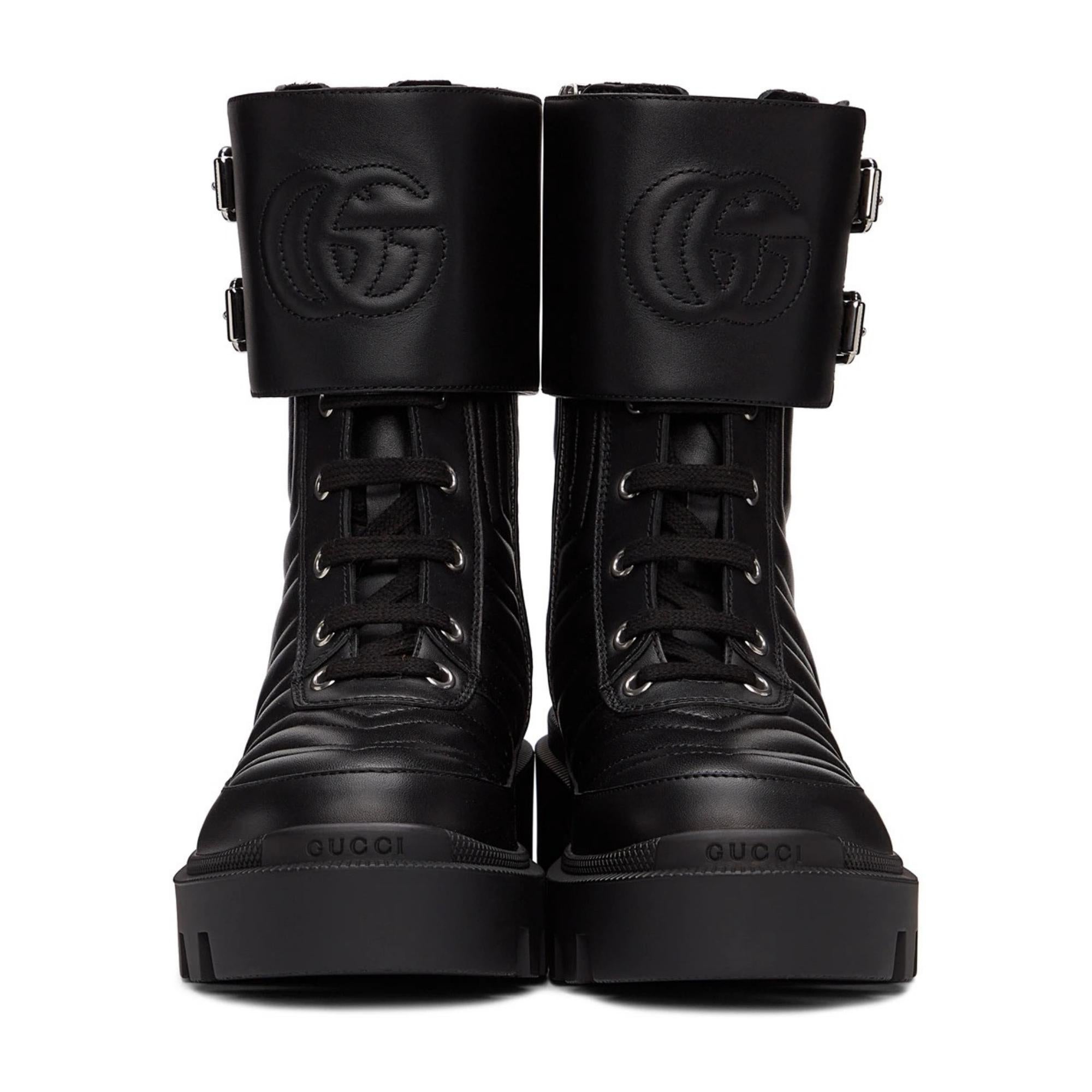 Ankle-high quilted buffed leather boots in black. Logo embossed at round toe. Tonal lace-up closure. Adjustable pin-buckle strap featuring quilted logo at collar. Zip closure at inner size. Textured rubber platform midsole. Treaded rubber outsole.