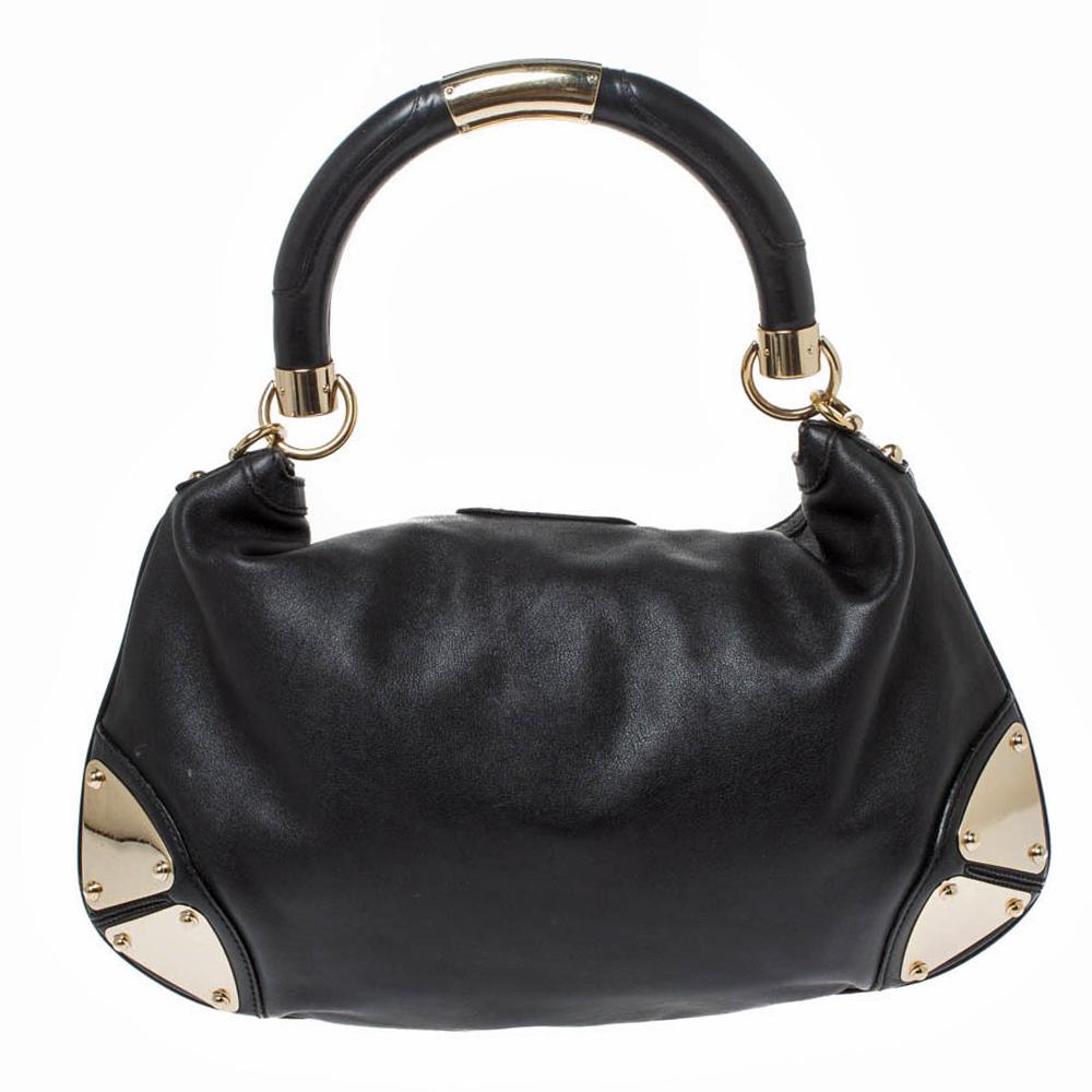 Crafted from leather, this Gucci Babouska Indy hobo has a top with two bamboo-detailed tassels and a spacious fabric-lined interior. It also features a sturdy top handle, armored corners, and gold-tone hardware. Flaunt this black beauty wherever you