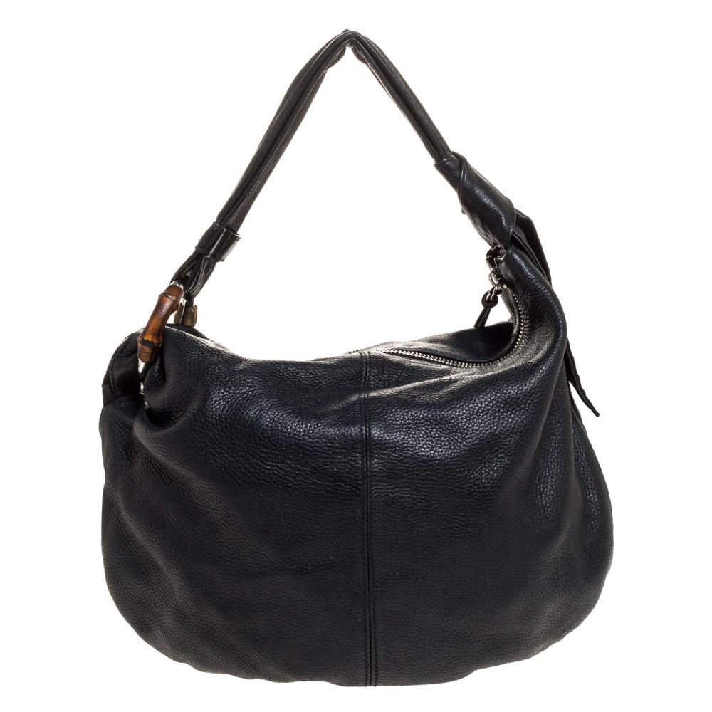 A handbag to last you years in great shape and state is this Jungle hobo from Gucci. Crafted from black leather in Italy, this gorgeous number has a spacious fabric-lined interior to assist you with ease. It features a single handle and a tassel