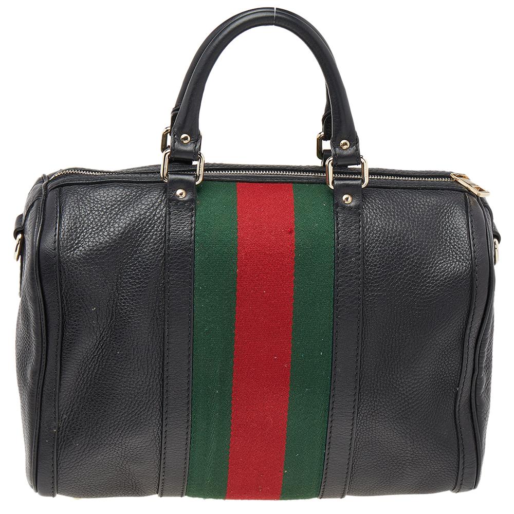 The charm of this Gucci Duffle bag lies in its simple design and seamless construction. The bag is crafted from leather and the two handles on top, the shoulder strap, and the spacious fabric interior add to the utility of the bag. The carryall is