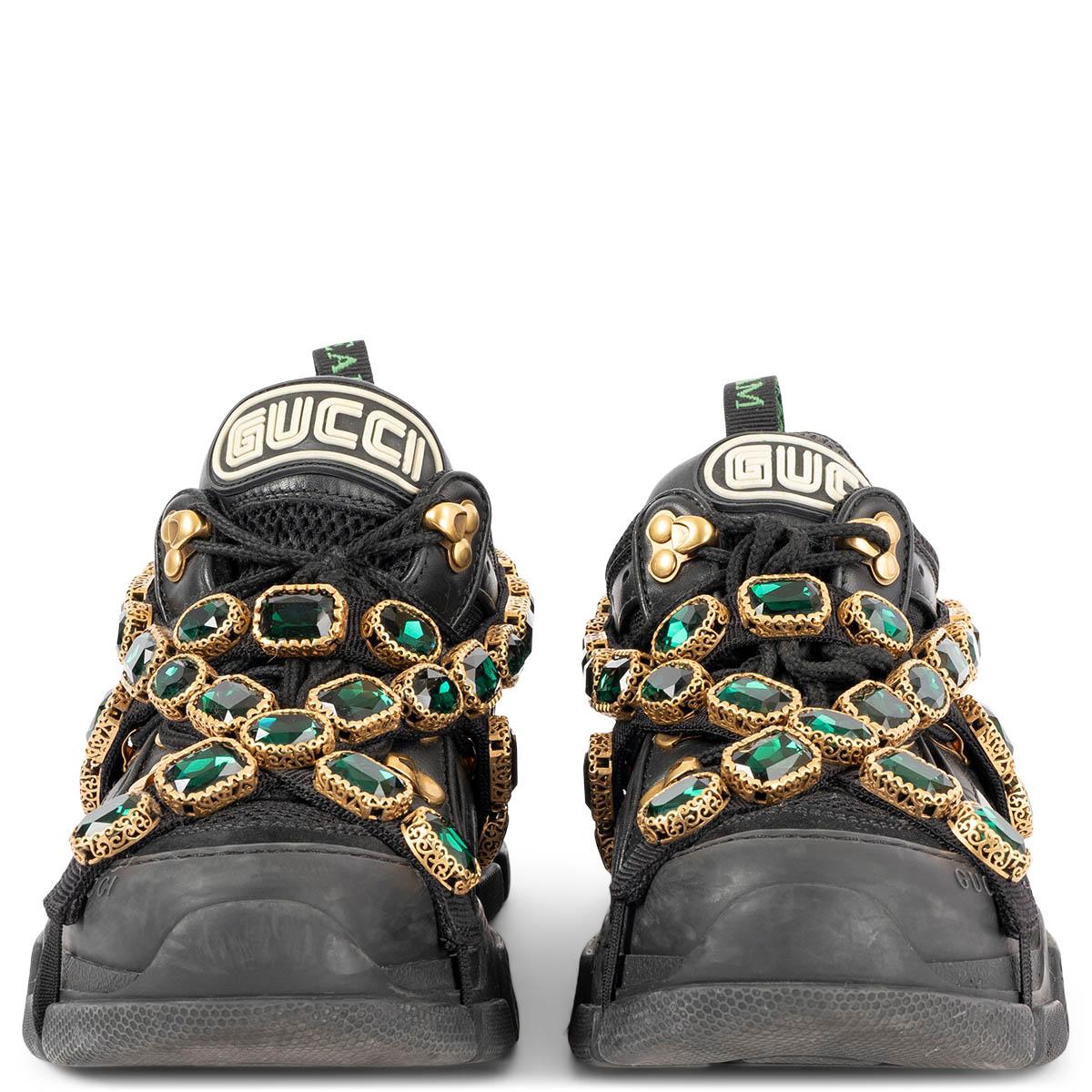 100% authentic Gucci Flashtrek sneakers in black leather, suede and technical fabric with rubber lug sole from the fall/winter 2018 collection runway. Sparkling green crystals are embroidered onto a removable elastic strap, wrapping around these