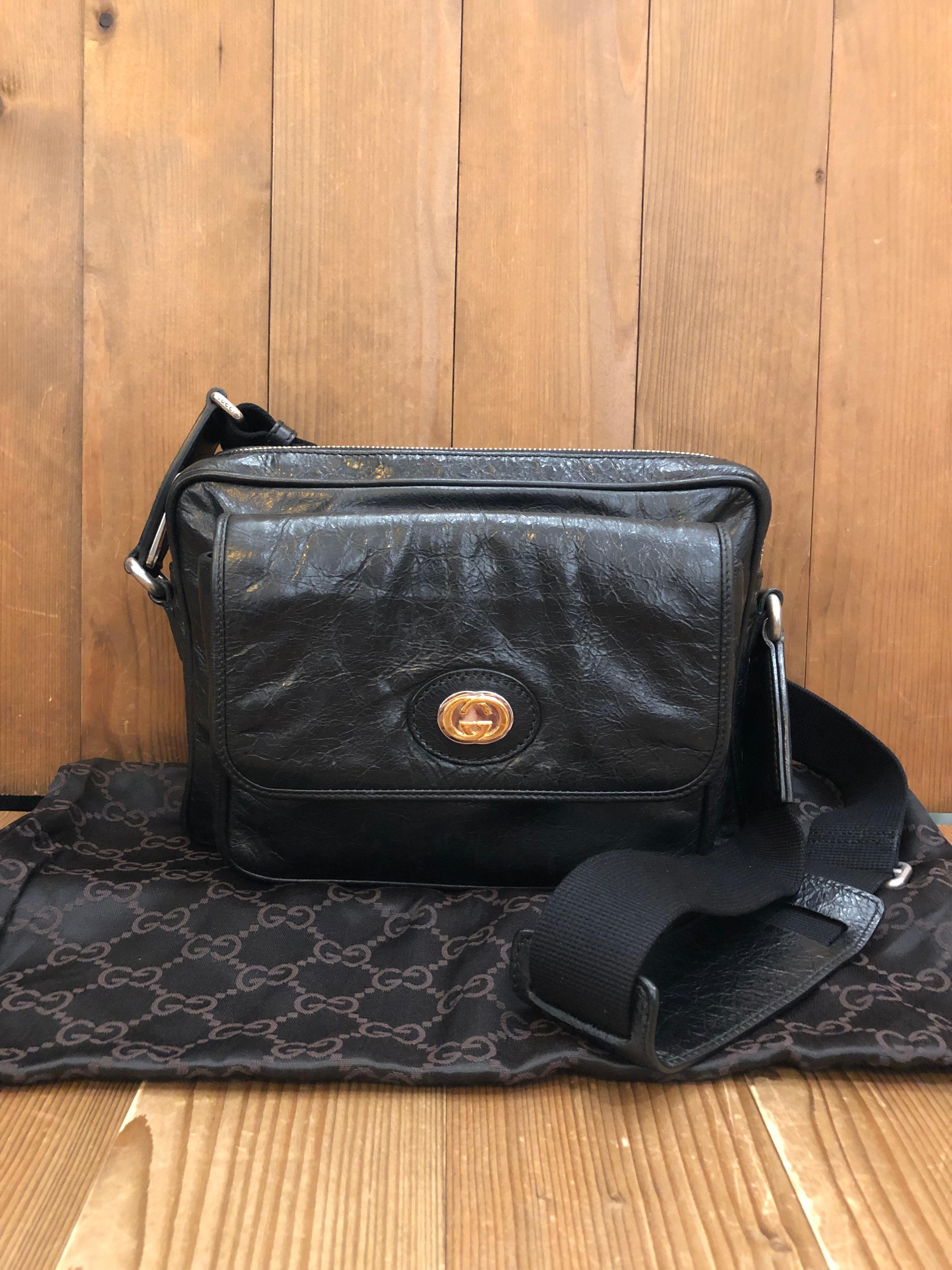This GUCCI camera bag is crafted of distressed calfskin leather in black featuring silver hardware and gold/silver-toned GG Morpheus logo. Top zipper closure opens to the main compartment lined with black canvas featuring a zippered pocket. Front