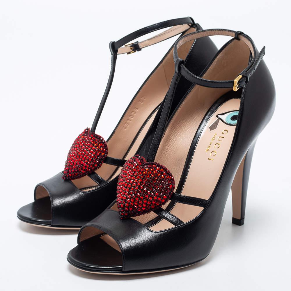 The crystal heart placed expertly on the slender straps of this pair of Gucci pumps serves as a standout element. Crafted from leather, it flaunts a classy black shade, an ankle buckle closure, and 10.5cm heels.

Includes: Original Dustbag