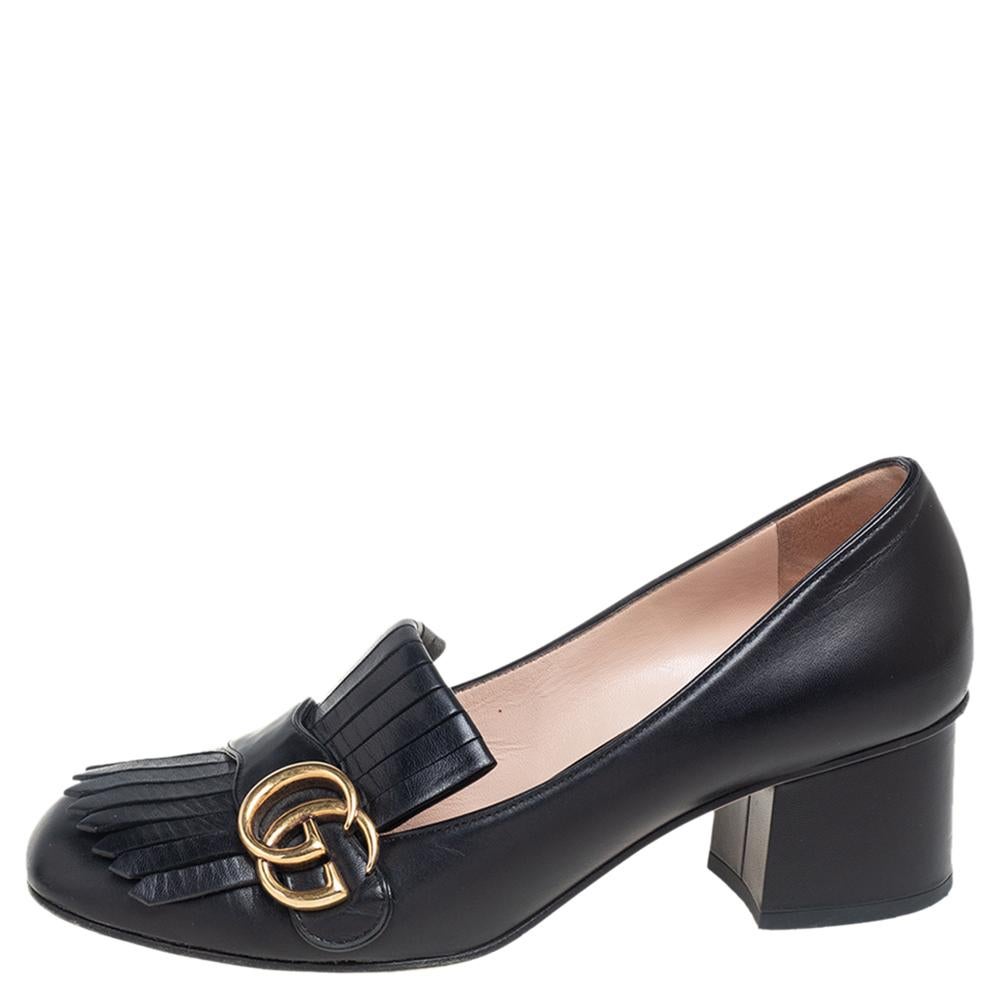 This pair of pumps by Gucci is a buy to wear and treasure. The shoes have been crafted from leather and styled with folded fringes with the brand's signature GG on the uppers. Square toes and a set of block heels complete the pair.

Includes: