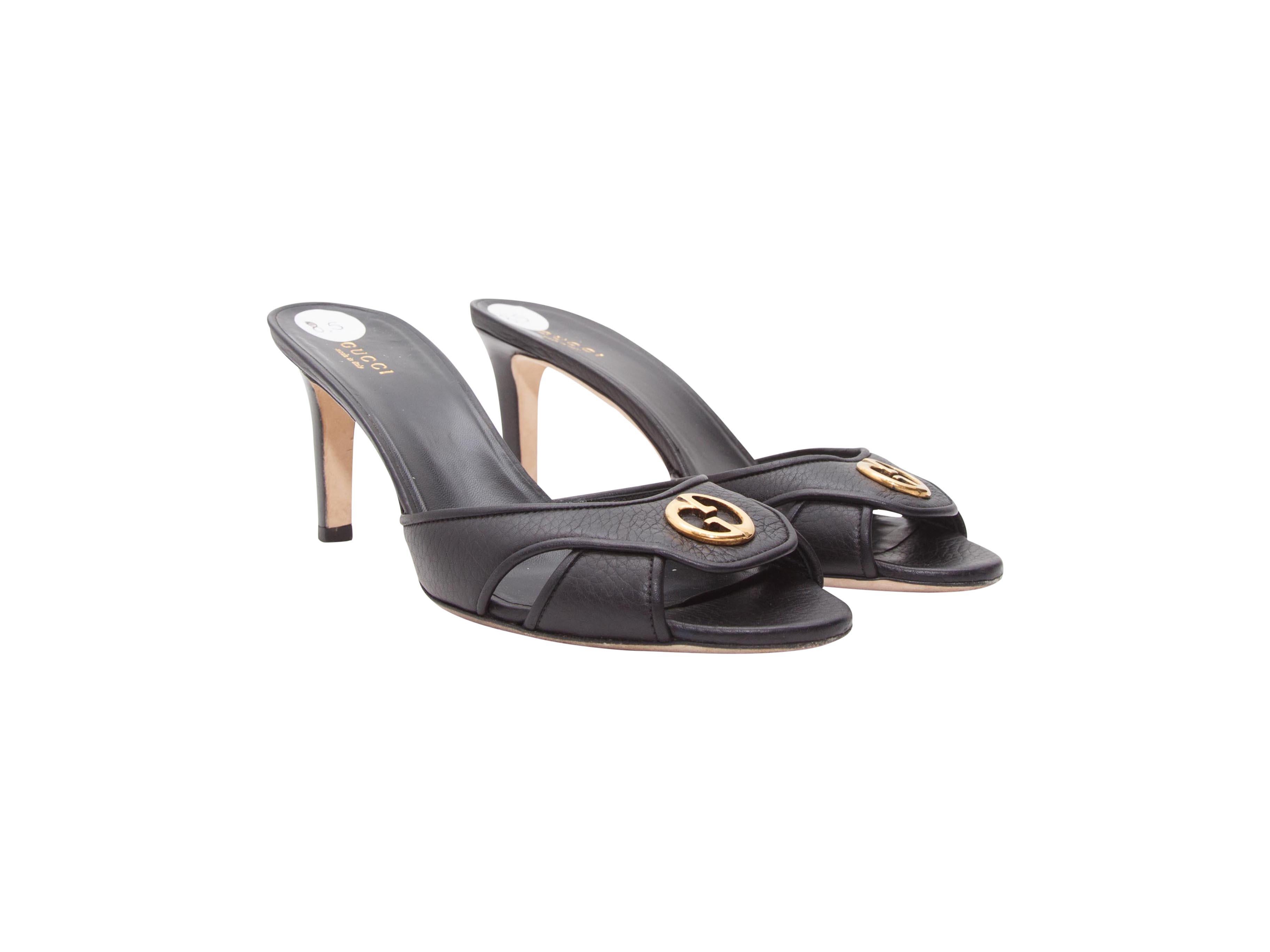 Product details:  Black leather mule kitten heels by Gucci.  Logo detail accents vamp.  Open toe.  Slip-on style.  Goldtone hardware.  3