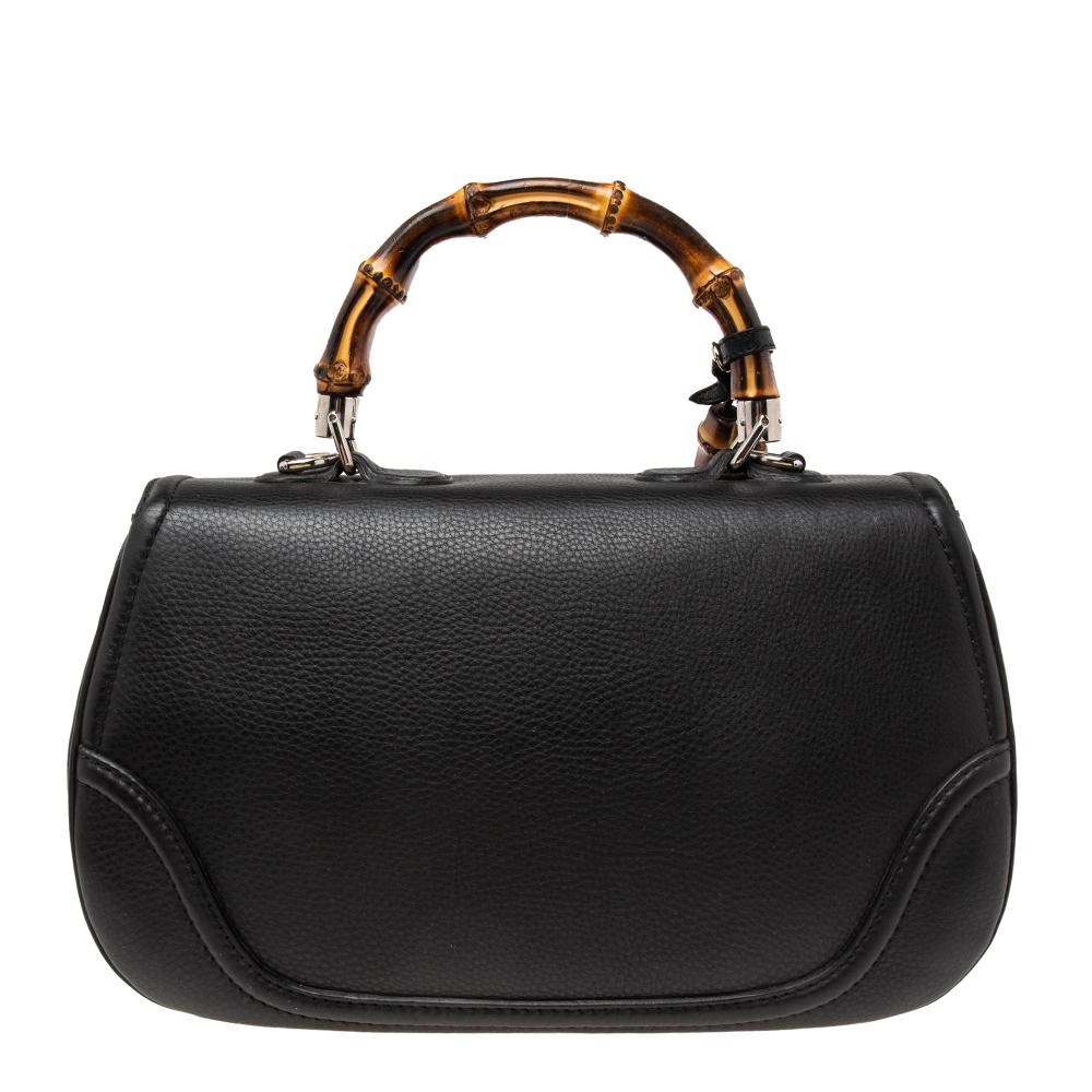 This Gucci bag combines style and elegance into the ultimate everyday bag. Crafted from leather, it is accented with the signature bamboo top handle. Secured with a bamboo lock closure, the interior is lined with canvas and has a well-sized