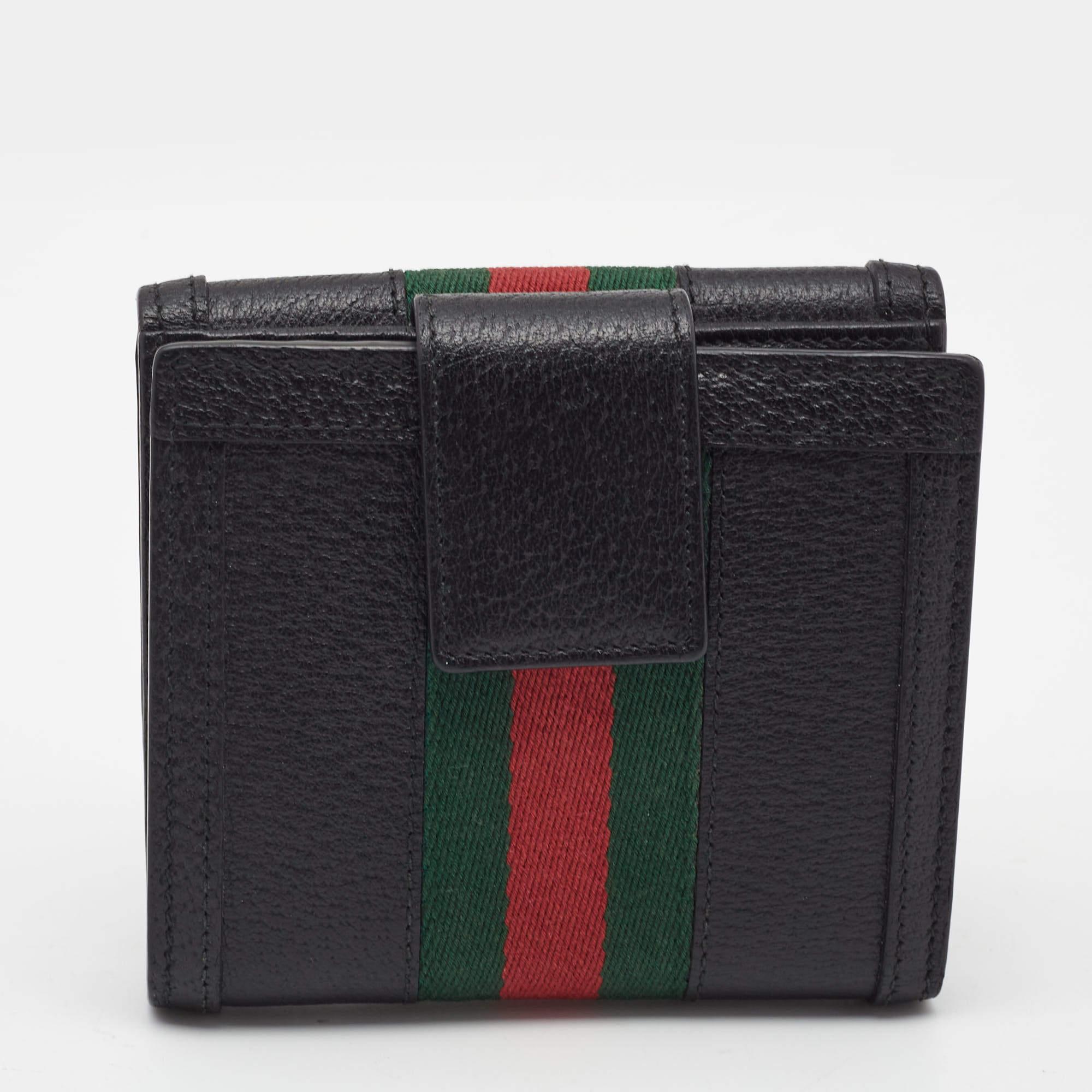 The house of Gucci makes sure you stay at the top of your accessory game with this pretty wallet. Crafted from leather, it has a flap closure and multiple card slots for easy organization. The piece is complete with the signature Web stripe design