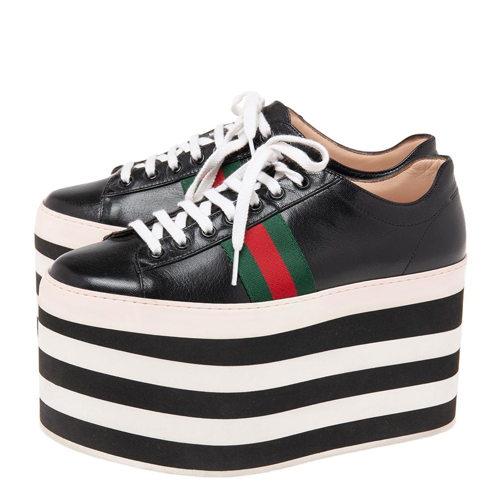 One's wardrobe is incomplete without a good pair of sneakers and what better than these Gucci ones! These Peggy sneakers have been crafted from black leather and styled with round toes, lace-up on the vamps, and the signature Web detailing on the