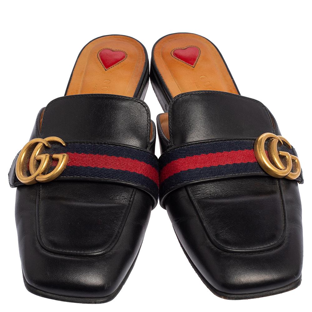 These Gucci Peyton flat mules are easy to style, comfortable, and versatile. Constructed in black leather, this stunning pair of shoes feature covered toes along with the signature Web detailing and GG logo on the uppers.

