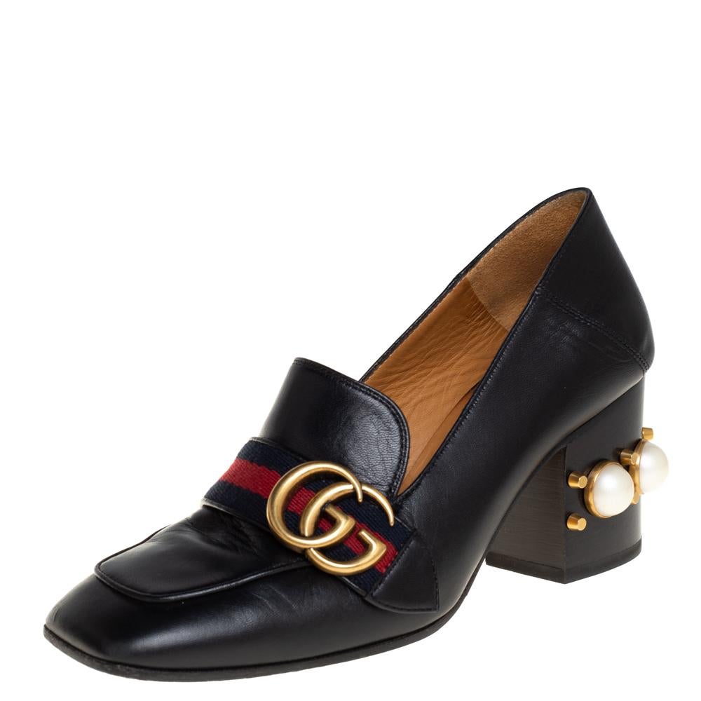 What a wonderful sight! These Gucci pumps just bring joy to one's eyes. They are made from black leather and designed with signature web straps carrying the GG logo and low block heels embellished with studs and faux pearls. The pair is complete