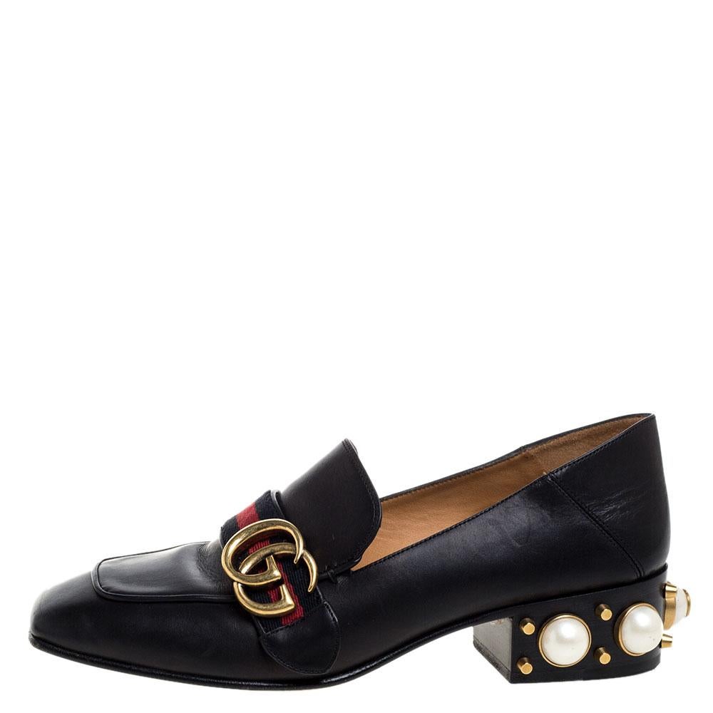 What a wonderful sight! These Gucci pumps just bring joy to one's eyes. They are made from black leather and designed with signature web straps carrying the GG logo and low block heels embellished with studs and faux pearls. The pair is complete