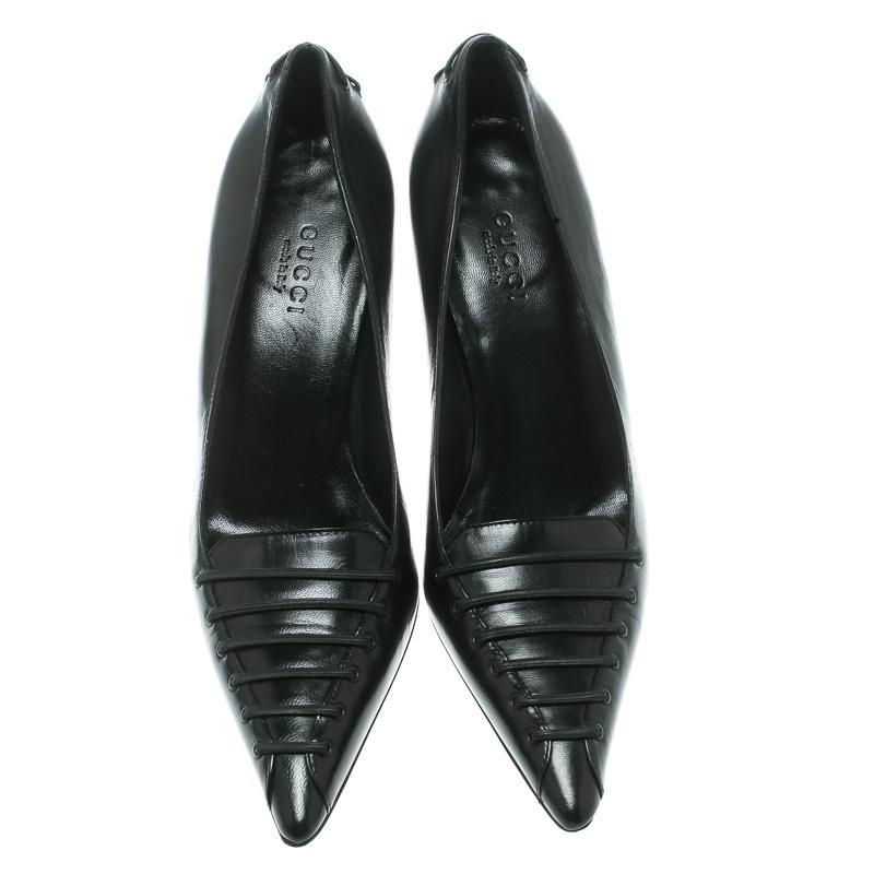 Revamp your footwear collection by adding this pair of classic Gucci pumps. They are leather-made, shaped into pointed toes and balanced on 8 cm heels. Elevate your formal and workwear by slipping into this pair of black beauties.

