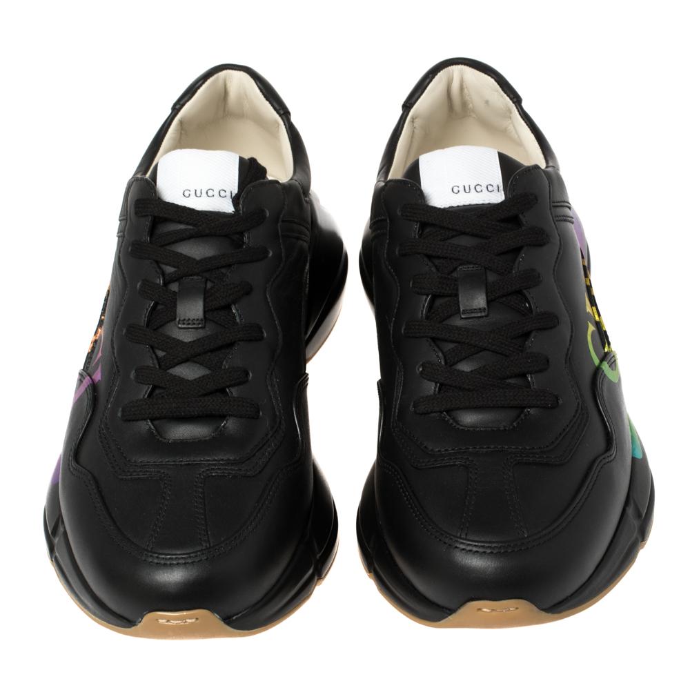 There exists many different iterations of Gucci's Rhyton sneakers since they debuted in 2018, but this has to be the most stunning pair yet. Made from supple leather in a black hue, they're illuminated with archival logo lettering in a holographic