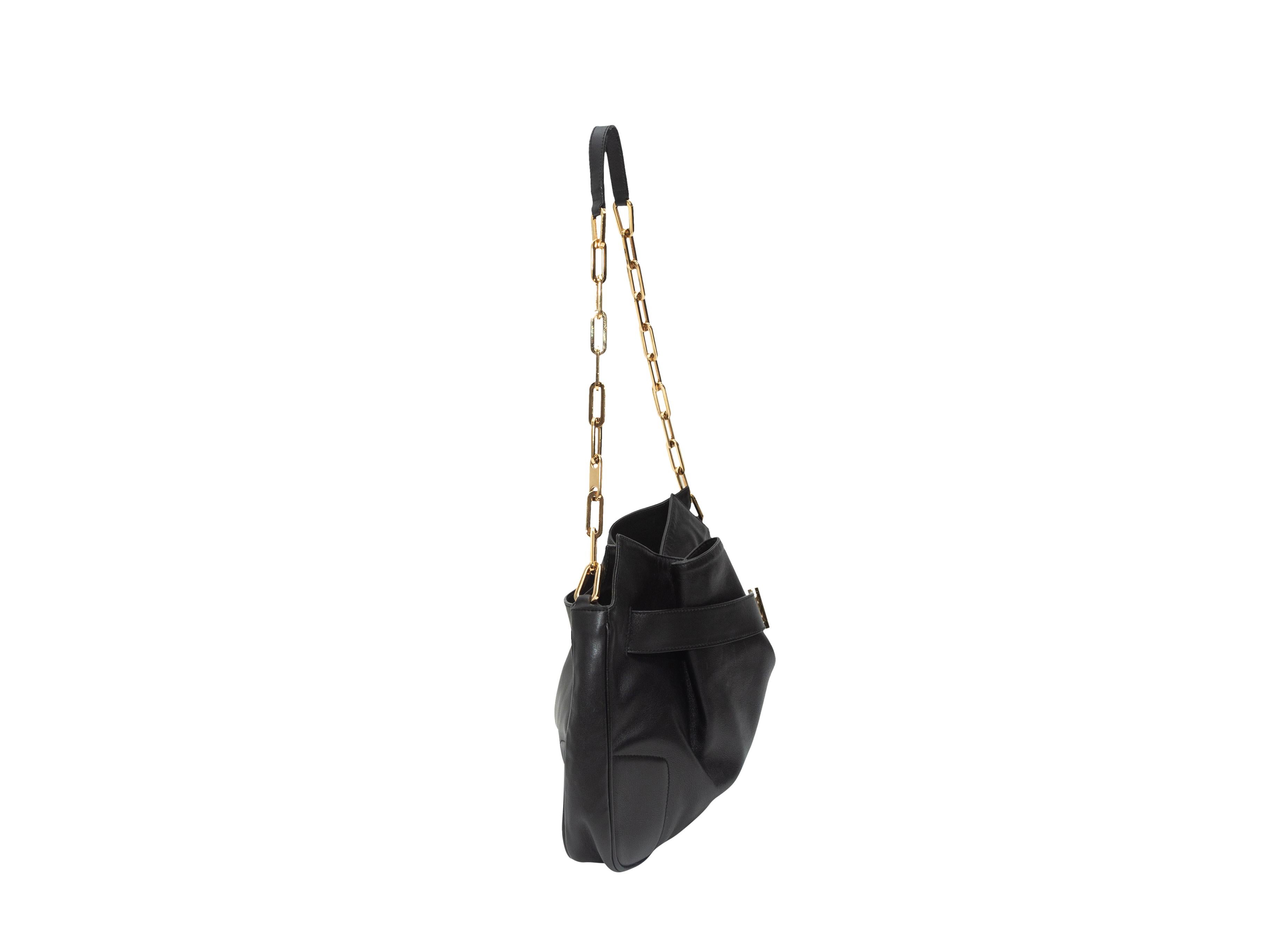 Product details: Black leather shoulder bag by Gucci. Gold-tone hardware. Interior zip pocket. Chain-link and leather shoulder strap. Buckle accent at front. 12