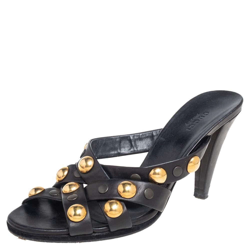 These Gucci sandals are simply stunning! They are crafted from black leather in a design of crisscross straps and gold-tone embellishments and styled with open toes, 10 cm heels, and comfortable insoles.

