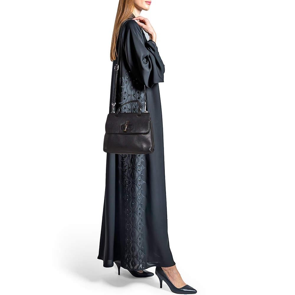 The Gucci Bamboo Daily bag is another favorite from the brands collection of bags for women. It features a leather exterior with a bamboo turn lock closure on the flap. A flat top handle and a detachable leather shoulder strap make this bag easy to