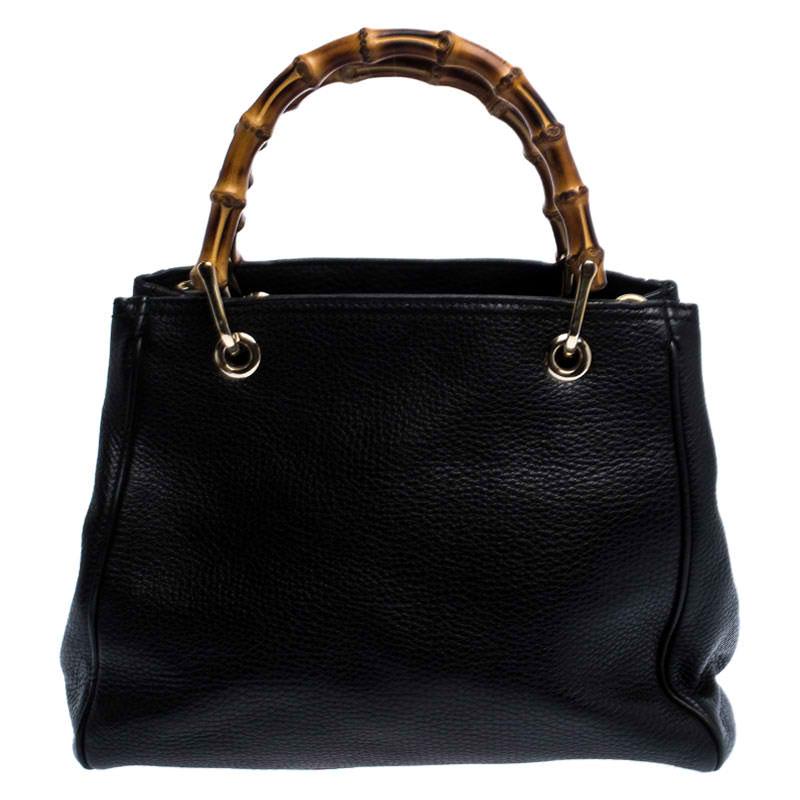 Designed with Gucci’s signature Bamboo top handles, this Shopper tote is instantly recognizable among fashion brand lover. This elegant style is finely created from smooth and soft black leather and is finished with an embossed Gucci trademark on