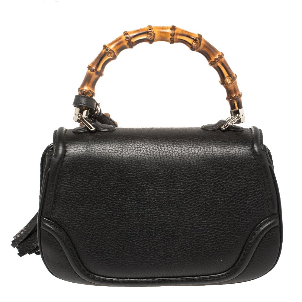 The New Bamboo bag is a Gucci gem that joins the brand's list of investment-worthy designer bags. Crafted in black leather, the bag has a flap design secured by a bamboo turnlock. It is lined with canvas and held by a bamboo top handle and a