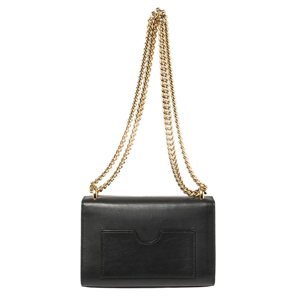 Swing this gorgeous bag and fetch endless compliments. This Gucci creation has been beautifully crafted from black leather with a flap that carries a signature padlock. The insides are lined with Alcantara and sized to dutifully hold your little