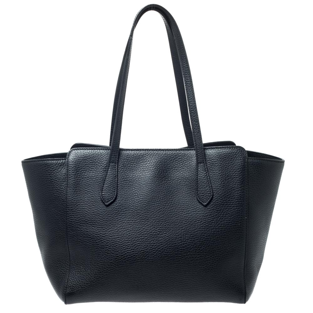 High on appeal and style, this tote is a Gucci creation. It has been crafted from leather in Italy and shaped to exude class and luxury. The bag comes with two handles, a spacious canvas interior, and the brand label on the front. This tote is ideal