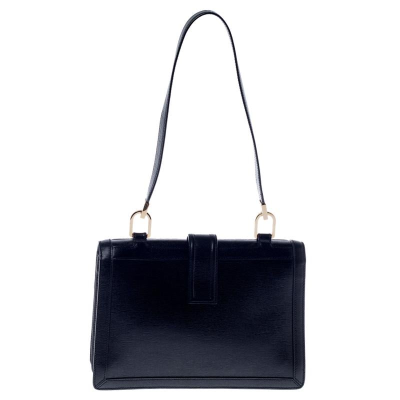 Now, this Gucci Flap bag is what a lady would love to flaunt. This bag is crafted from leather, featuring a shoulder strap. This bag accentuates a flap closure with impressive G logo in gold-tone. It reveals a nylon-lined interior and carries brand