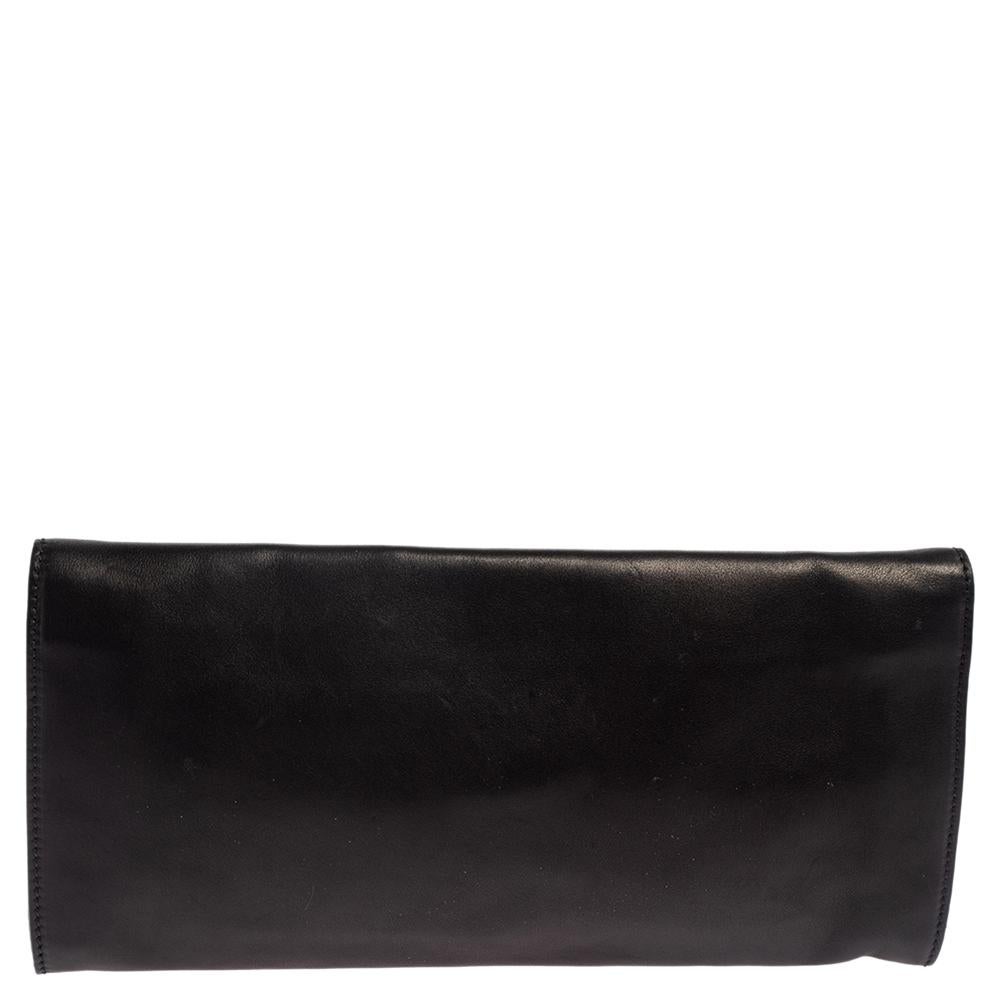 This striking clutch is from the house of Gucci. This black clutch has a luxe appeal with a studded front flap, a well-designed interior, and gold-tone hardware. Add this black clutch to your collection today!

