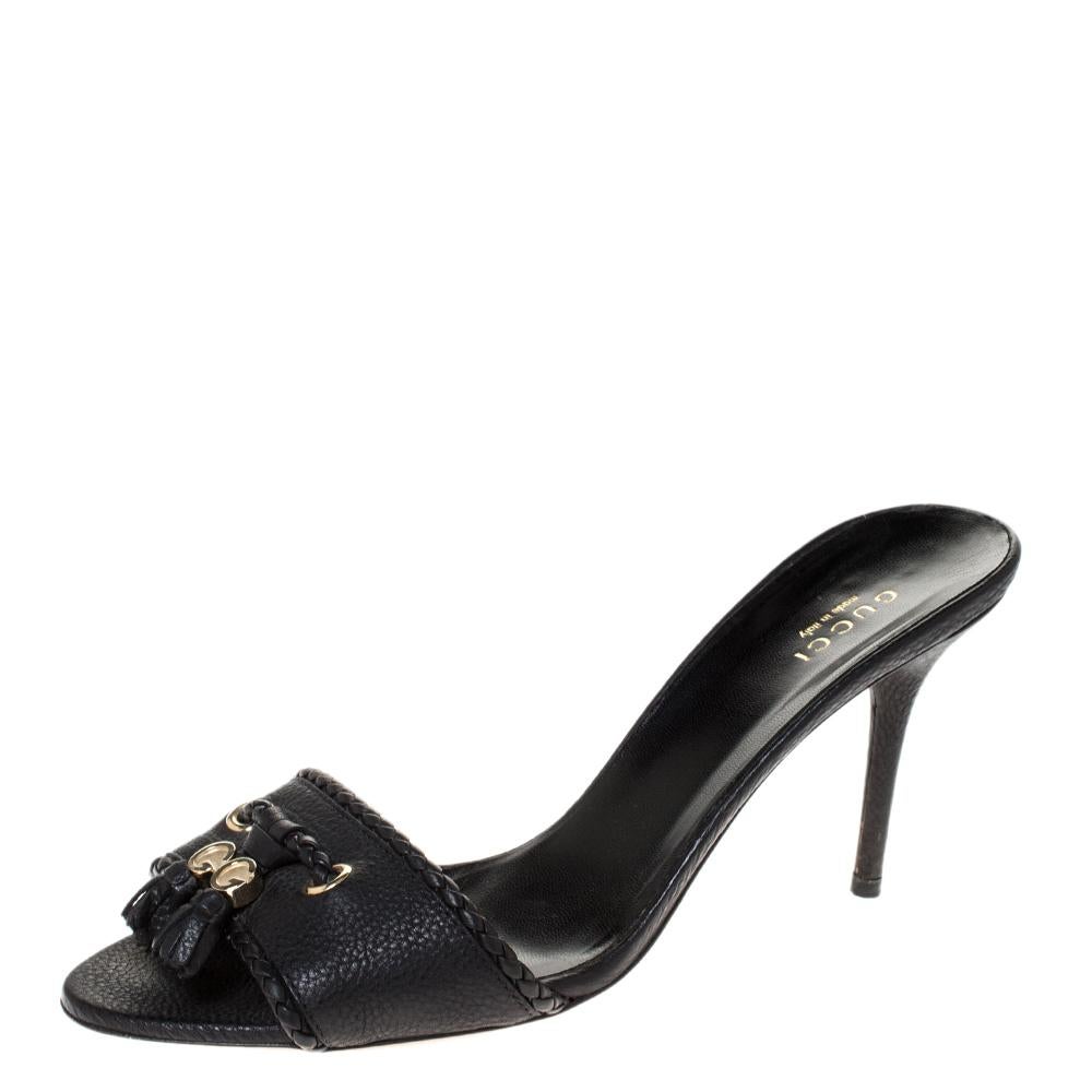 These black sandals by Gucci are absolute classics. Crafted with quality leather straps at the front, they feature braided leather trims, tassel detailing, gold-tone hardware and insoles that carry brand labelling. These slides are elevated on 8.5