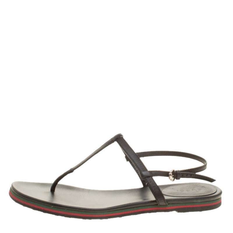 Opt for a relaxed day out in these flat sandals from Gucci. They've been designed with style in mind and created from leather to provide soft comfort to your feet. Black in shade, the sandals have a thong design with buckle slingbacks and the web