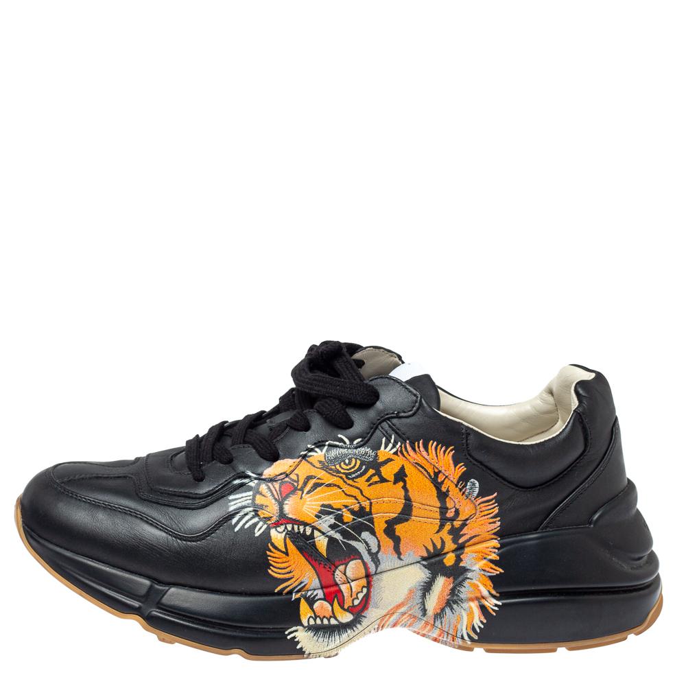 Project a stylish look every time you step out in these sneakers from Gucci. They are crafted from black leather and styled with lace-ups on the vamps and a tiger face print on the sides. They are equipped with comfortable leather-lined insoles and