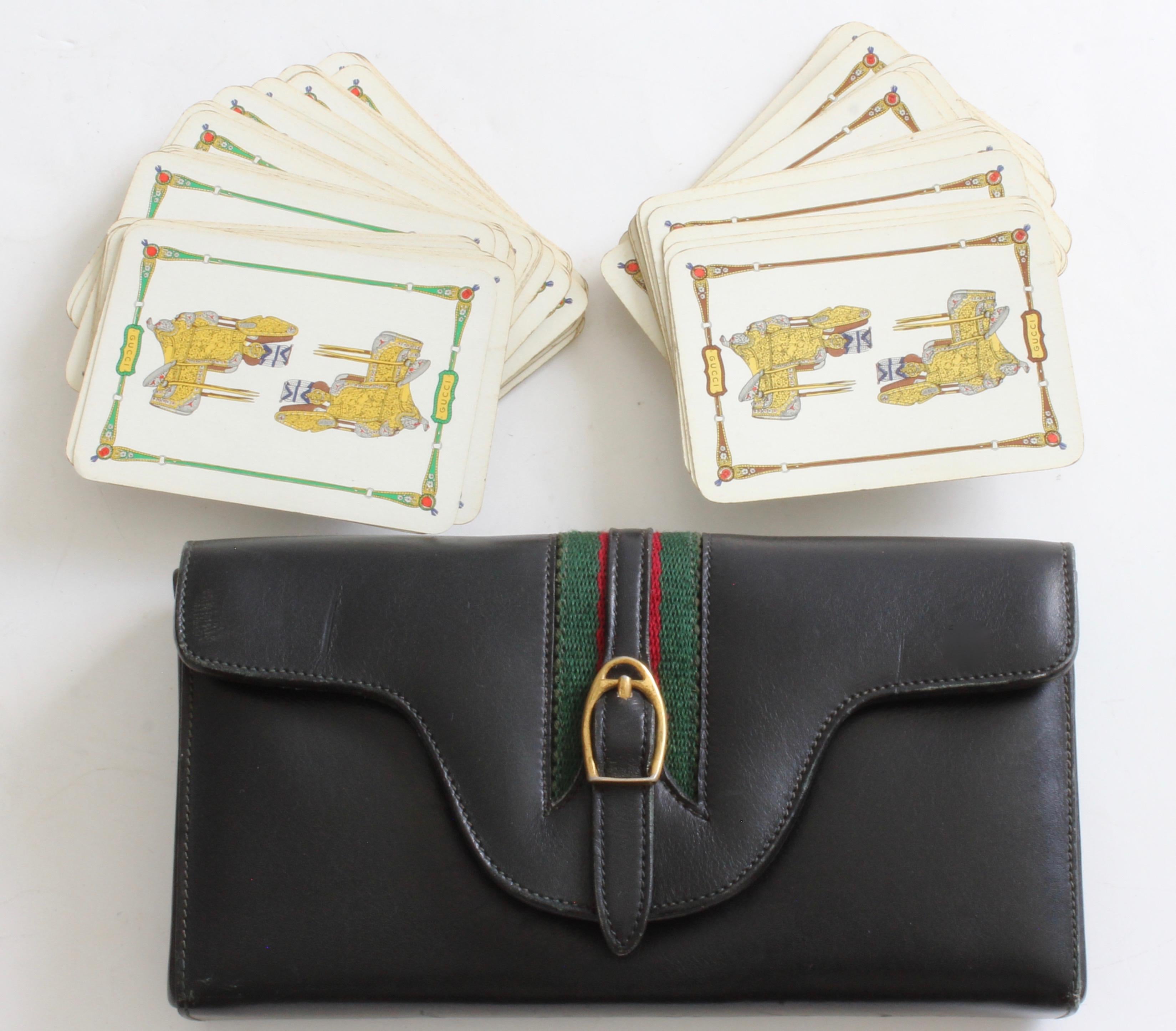This vintage game set was made by Gucci, most likely in the late 1970s.  The case is made from black leather and features their signature webbing at the center with an equestrian buckle. Inside, the case is fully-lined in black leather and features