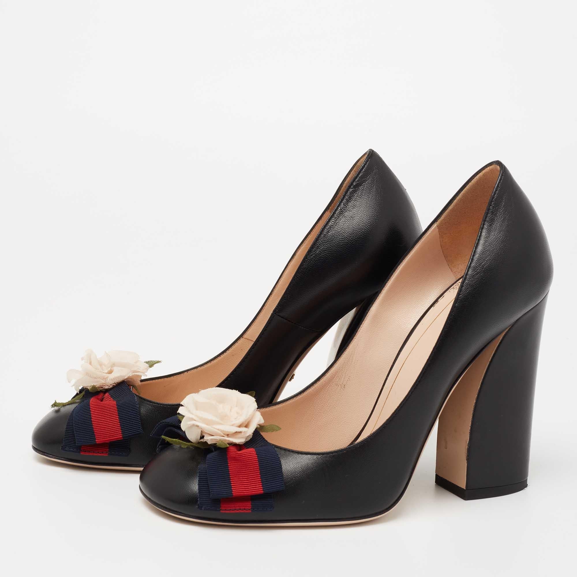 The black exterior of this pair of Gucci pumps is decorated with a floral motif on the Web bow. Constructed from leather, it is defined by round toes, gold-tone hardware, and block heels.

Includes: Original Dustbag