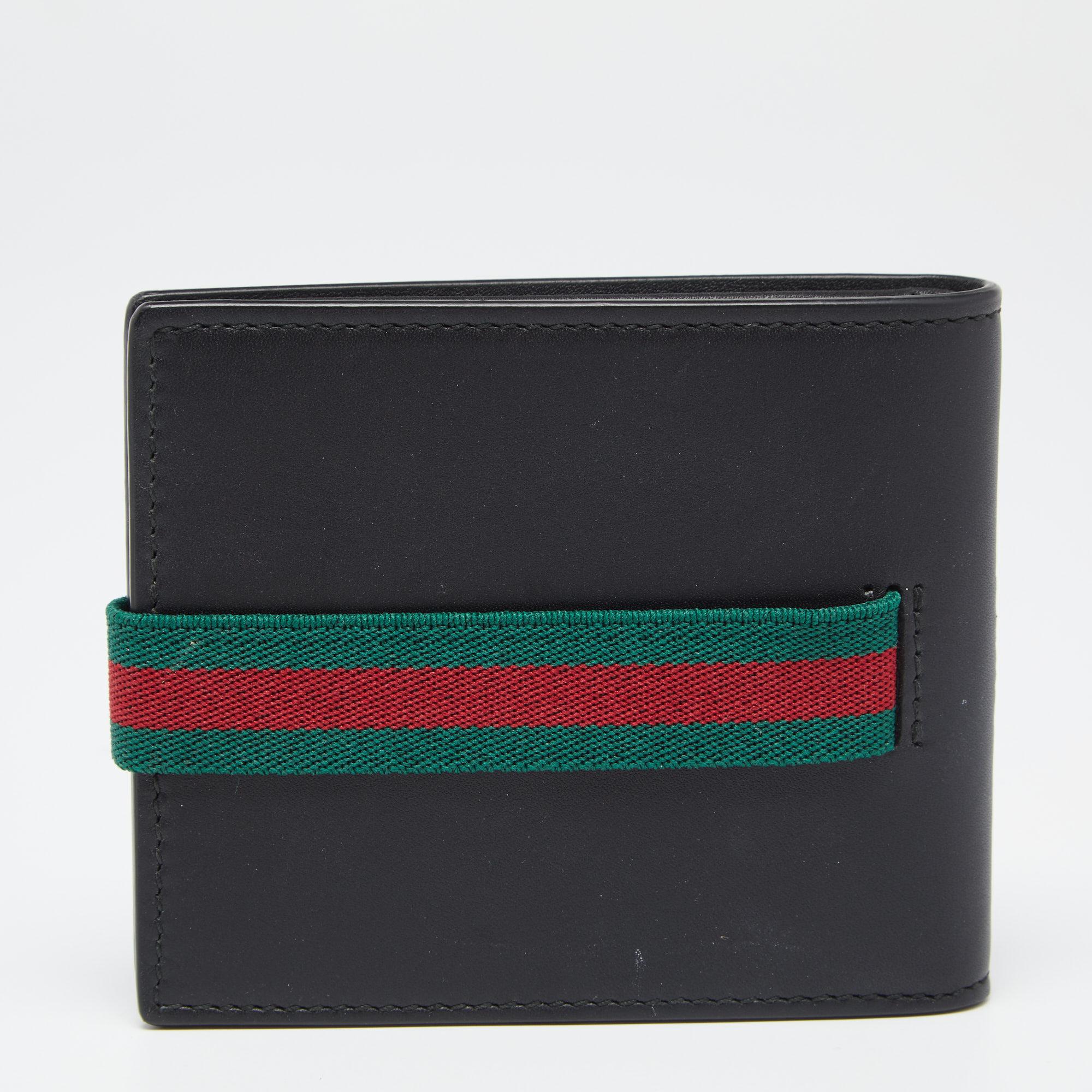 This stylish wallet is distinctively Gucci. Crafted in Italy, it is made of leather and comes in black. It has an elastic Web detail that keeps it secure. The interior is lined with leather and is equipped with multiple card slots and slip pockets