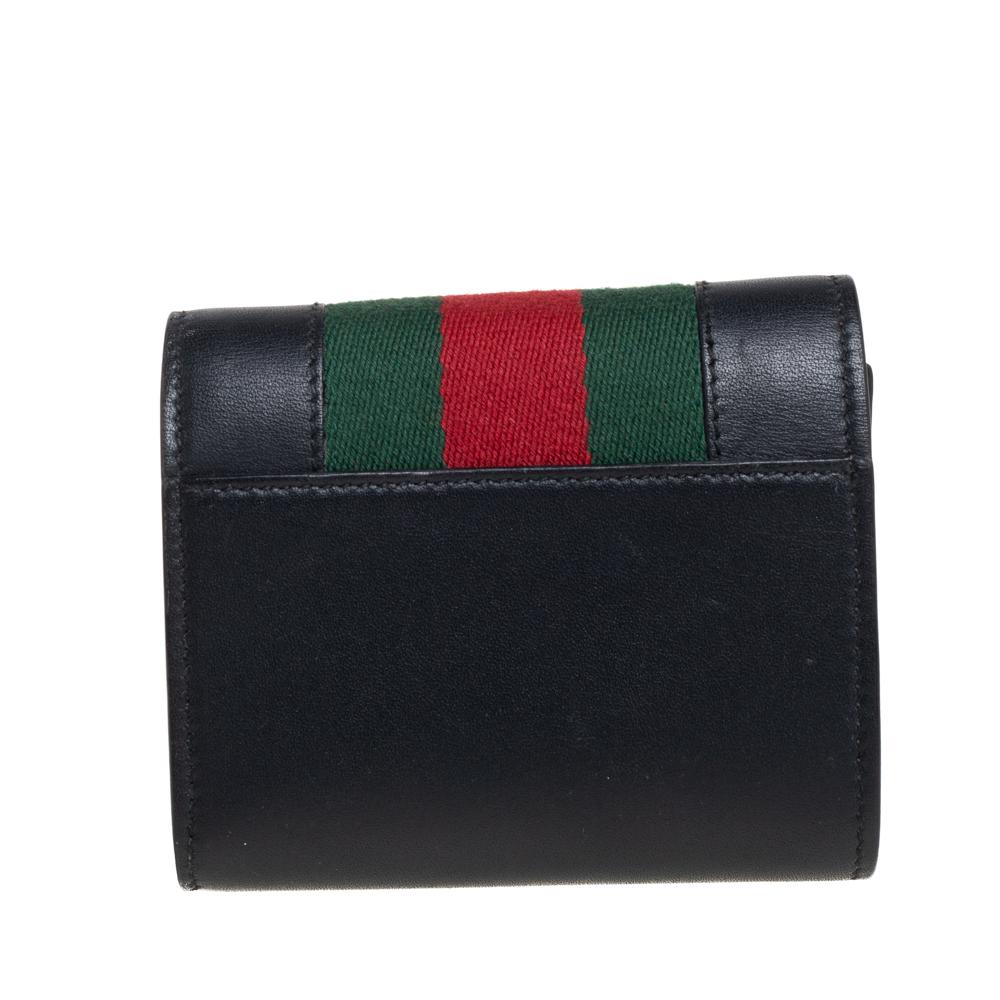 Carry Gucci's Sylvie wallet and flaunt an effortless style wherever you go. Elegance pairs with style for this remarkable black piece. Crafted from durable leather and styled with signature web detailing, you will find this wallet to be an ideal