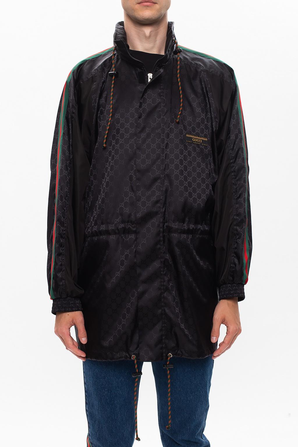 Size 52, Black jacket from Gucci. Rendered in technical fabric with the label's signature GG jacquard pattern, this piece has zip and velcro fastenings, a retractable hood, iconic green-red-green Web stripes down the sleeves, a logo patch, two zip