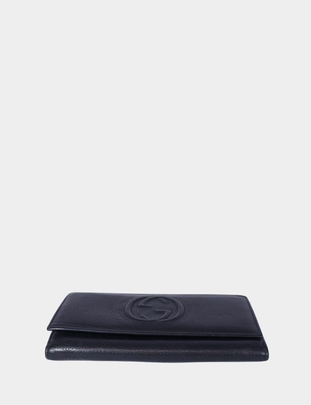Elevate your essentials with this classic Gucci black leather wallet. Crafted from premium pebbled leather, it features the iconic interlocking GG logo embossed on the front for a subtle yet luxurious finish. With multiple compartments for cards,