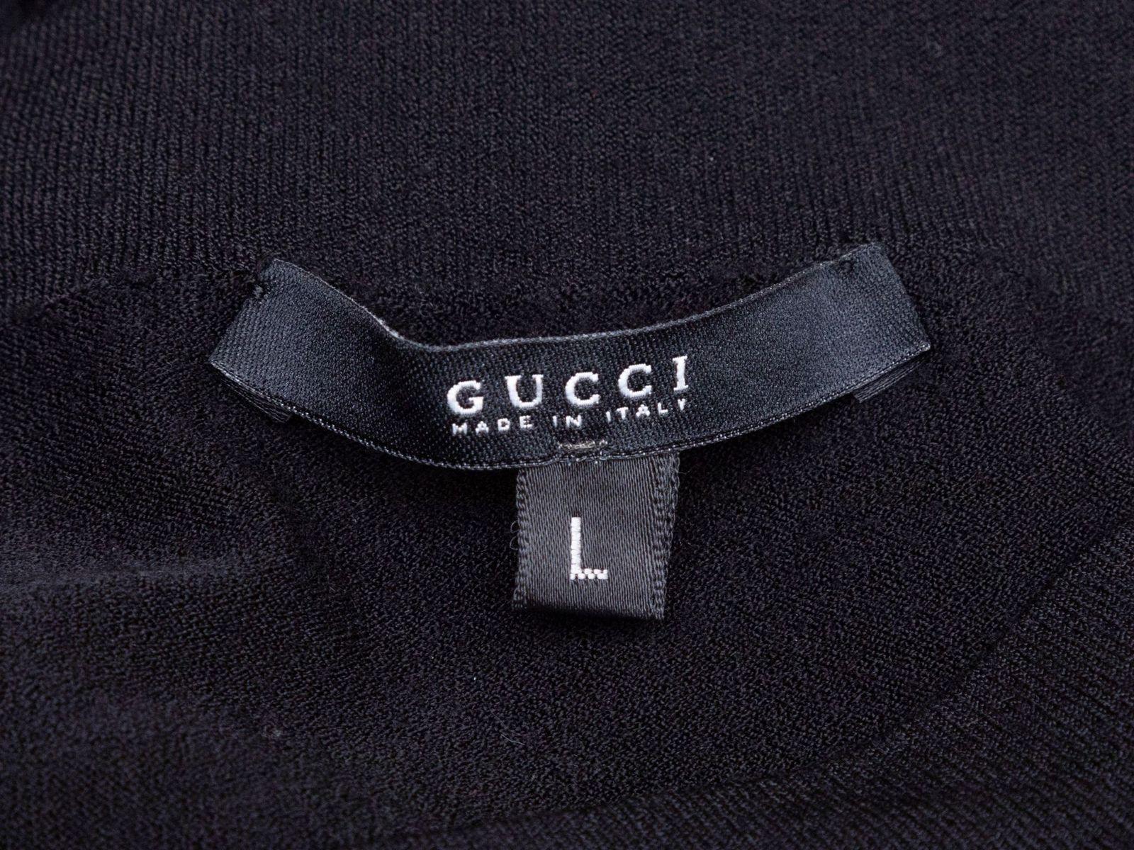 Product Details: Black long sleeve top by Gucci. V-neck. 36